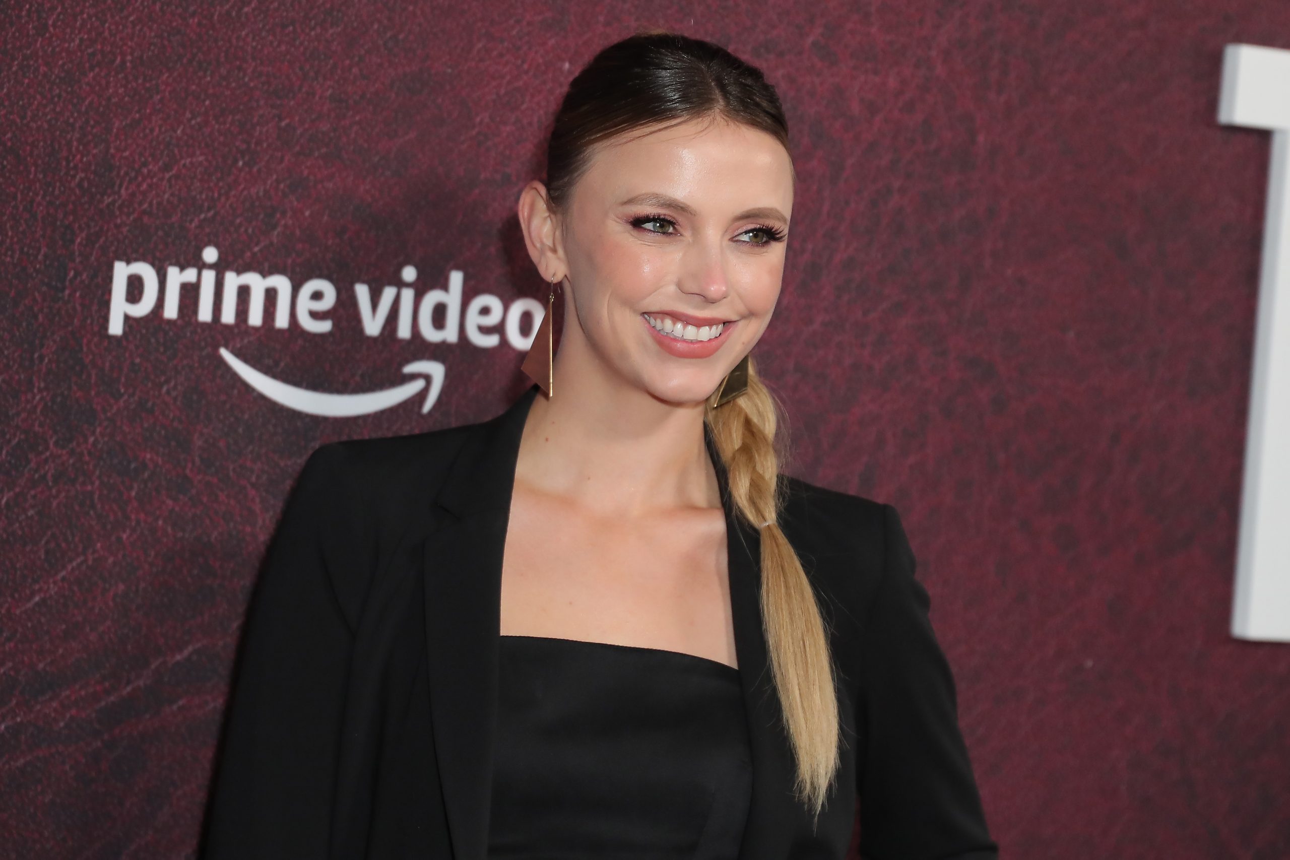 Chicago Med actor Riley Voelkel wearing black with her hair in a side braid. 