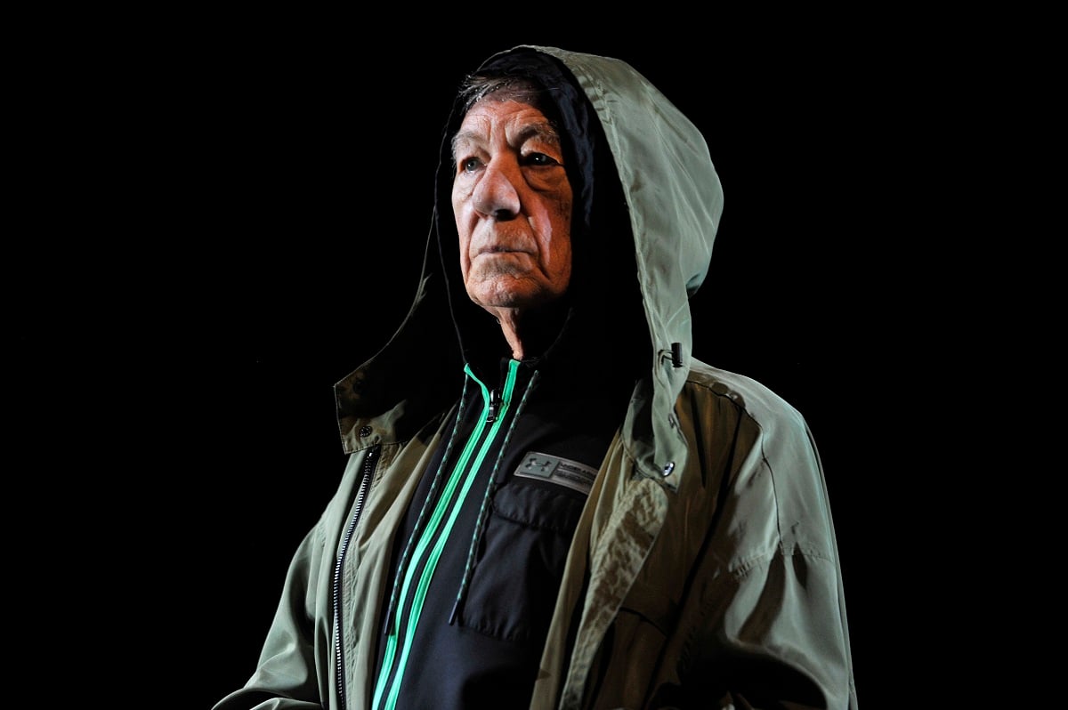 Ian McKellen posing while wearing a green jacket.