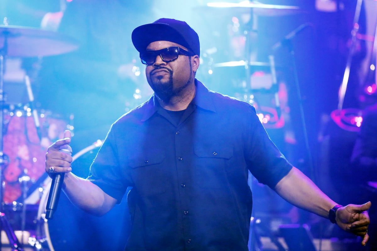 Ice Cube wears black and performs on stage