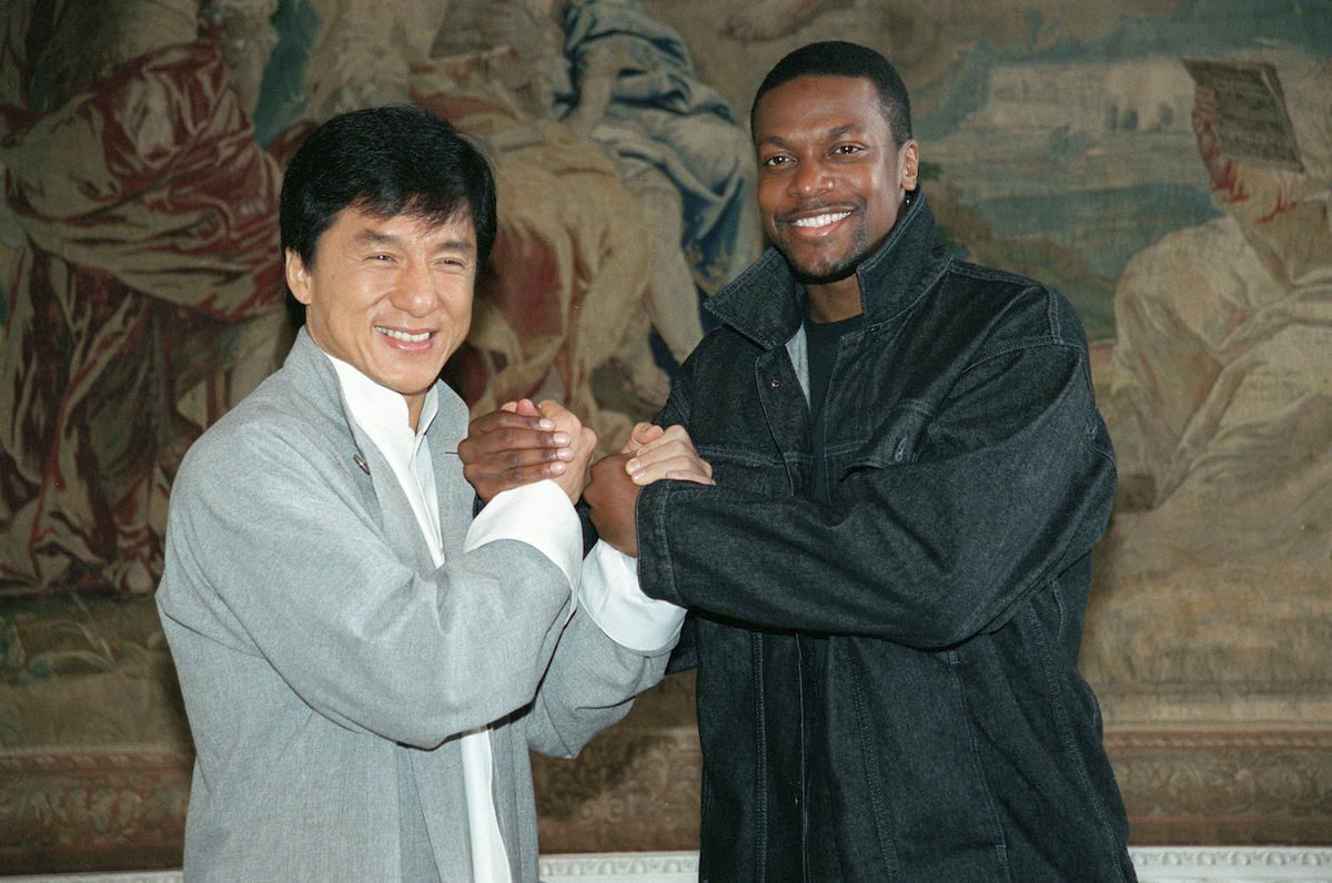 ‘Rush Hour’ stars Jackie Chan and Chris Tucker grasp each other hands in a smiling pose