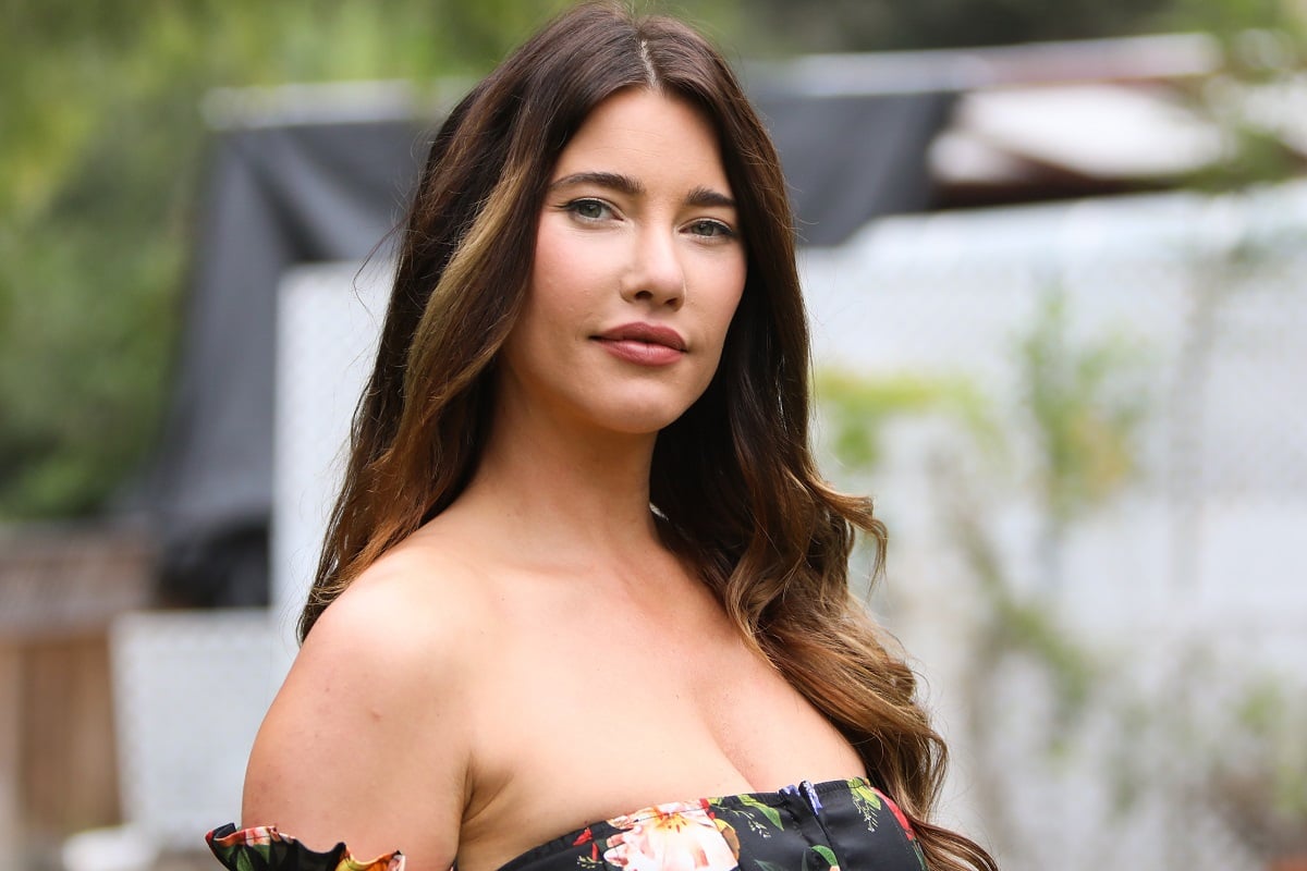 'The Bold and the Beautiful' actor Jacqueline MacInnes Wood wearing a black floral blouse, and standing outside.