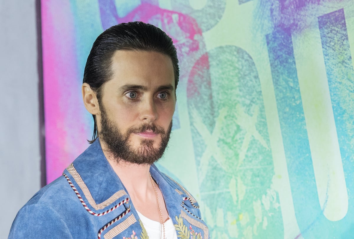 ‘Suicide Squad’ star Jared Leto poses in front of the movie's poster