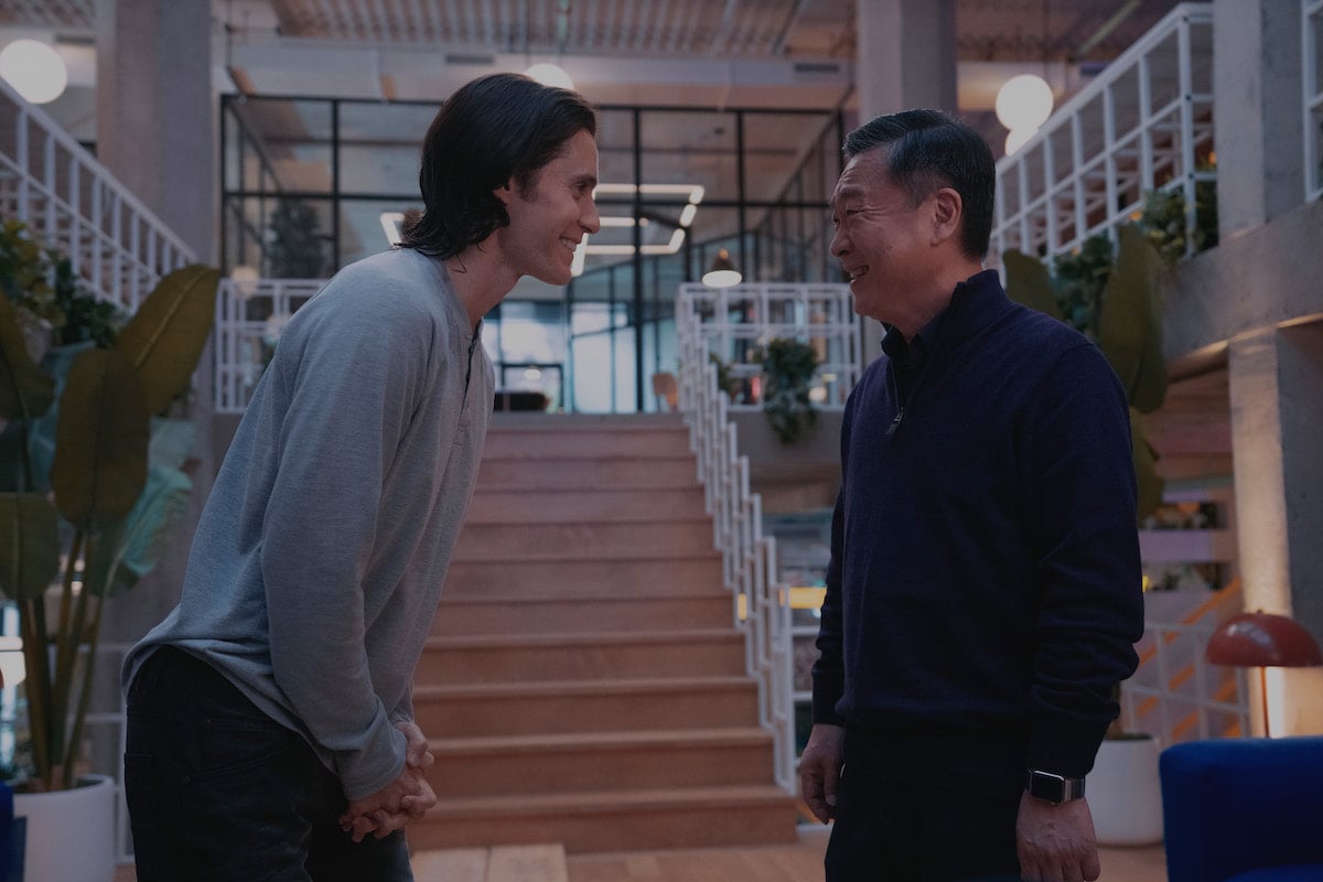 Jared Leto and Kim Eui-sung look at each other in a scene from 'WeCrashed' Season 1 Episode 4: '4.4'