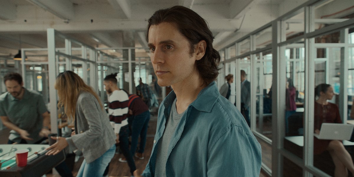 Jared Leto wears a blue t-shirt and blue button down shirt in 'WeCrashed' Season 1 Episode 1: 'This Is Where It Begins'