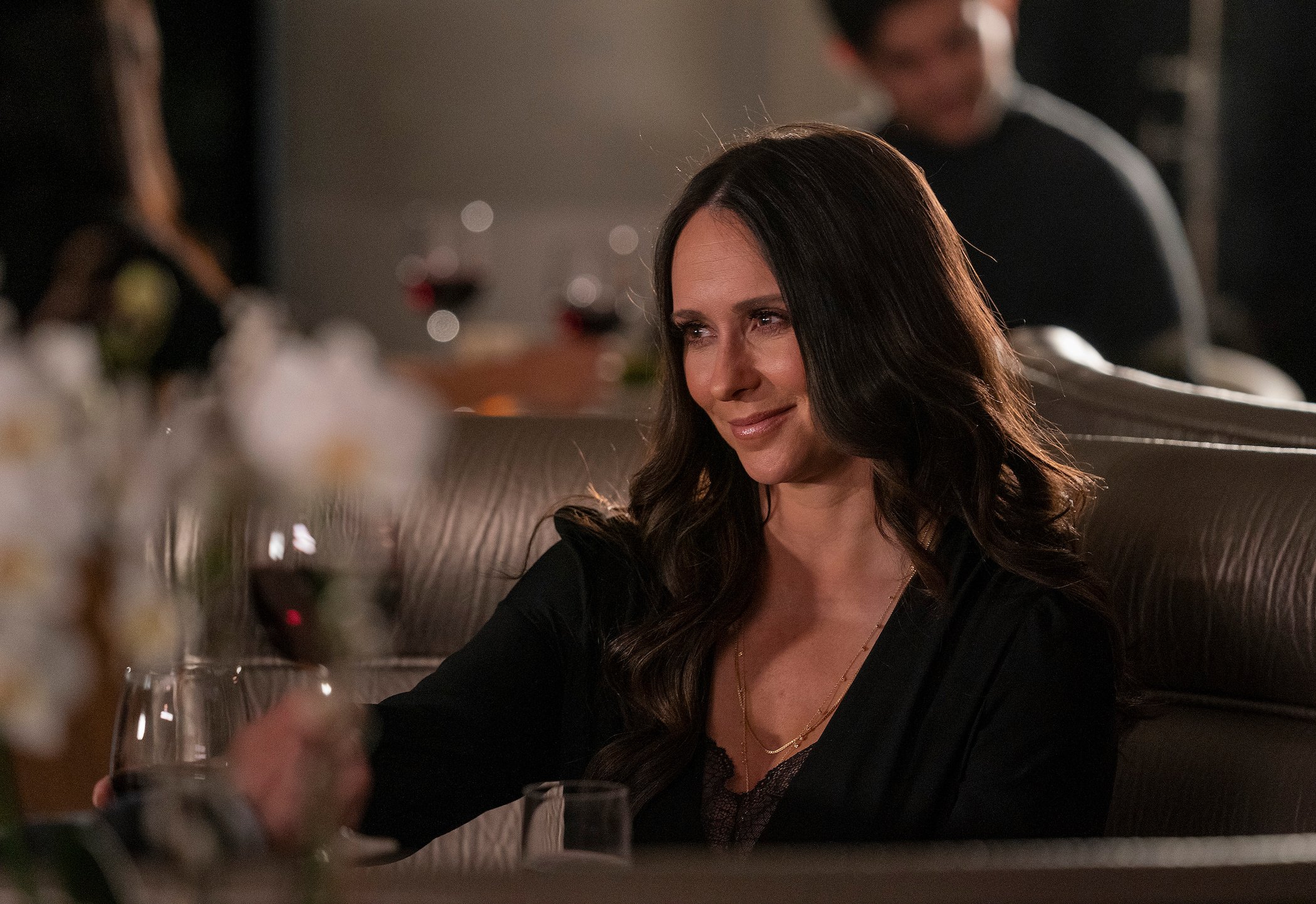 '9-1-1' Season 5 star Jennifer Love Hewitt as Maddie smiling while holding a glass of red wine