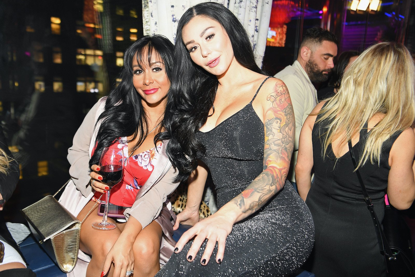 Nicole 'Snooki' Polizzi and Jenni 'JWoww' Farley attend MTV's Jersey Shore Family Vacation and pose together while seated for a photo 