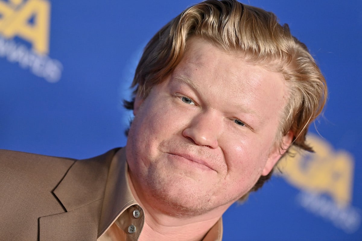 Jesse Plemons smiles in brown