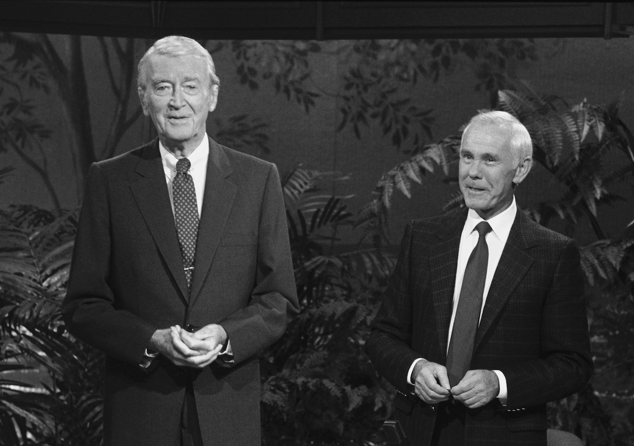 Black and white photo of Jimmy Stewart and Johnny Carson in suits, standing on 'The Tonight Show' set