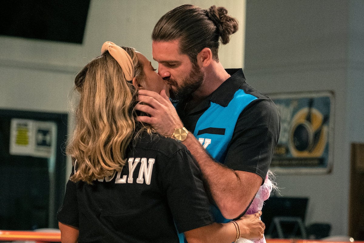 Carolyn Moore and Kurt Sowers kiss while filming 'Joe Millionaire: Richer or Poorer' at a bowling alley