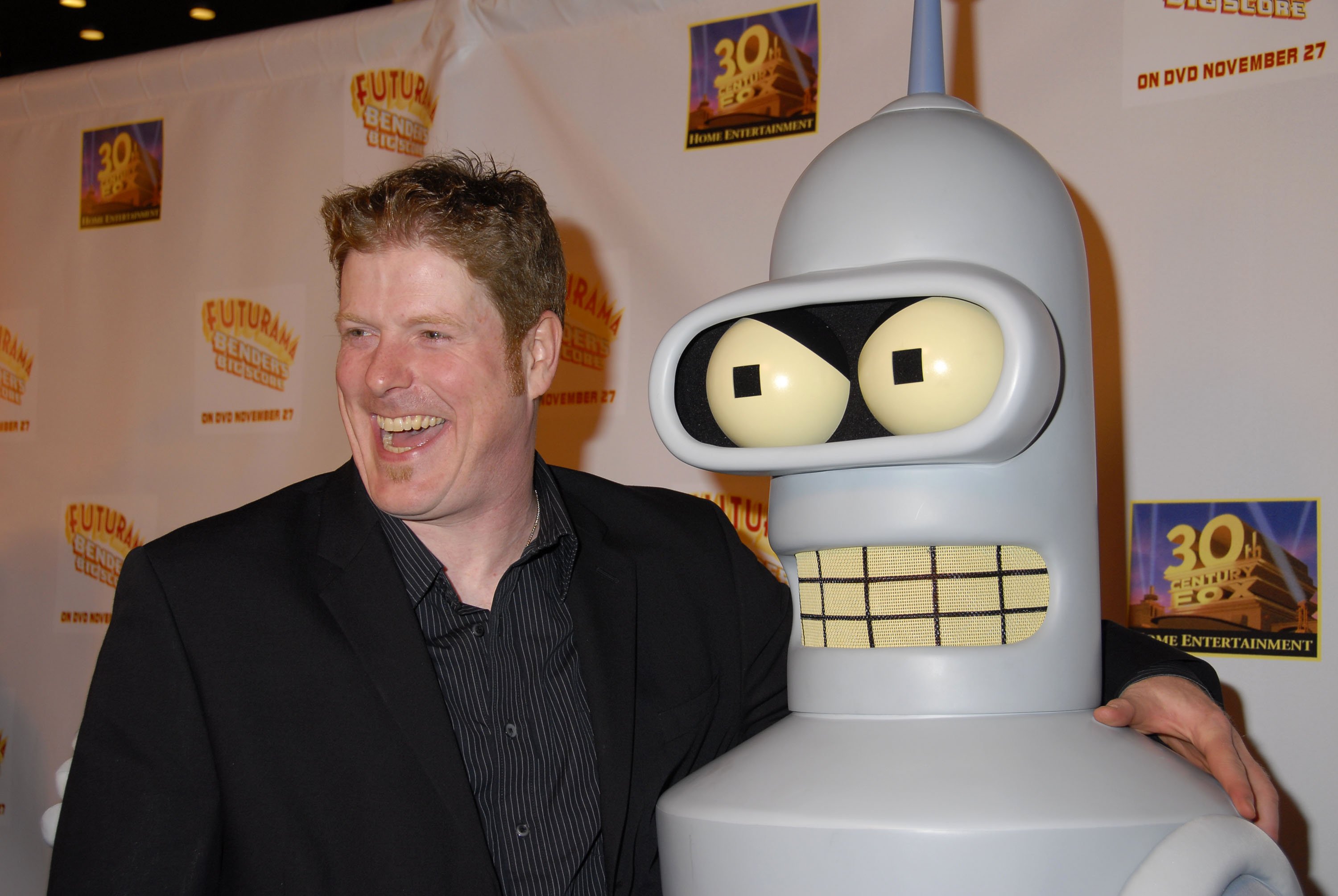 'Futurama' actor John DiMaggio poses with a mascot of his character Bender the robot.
