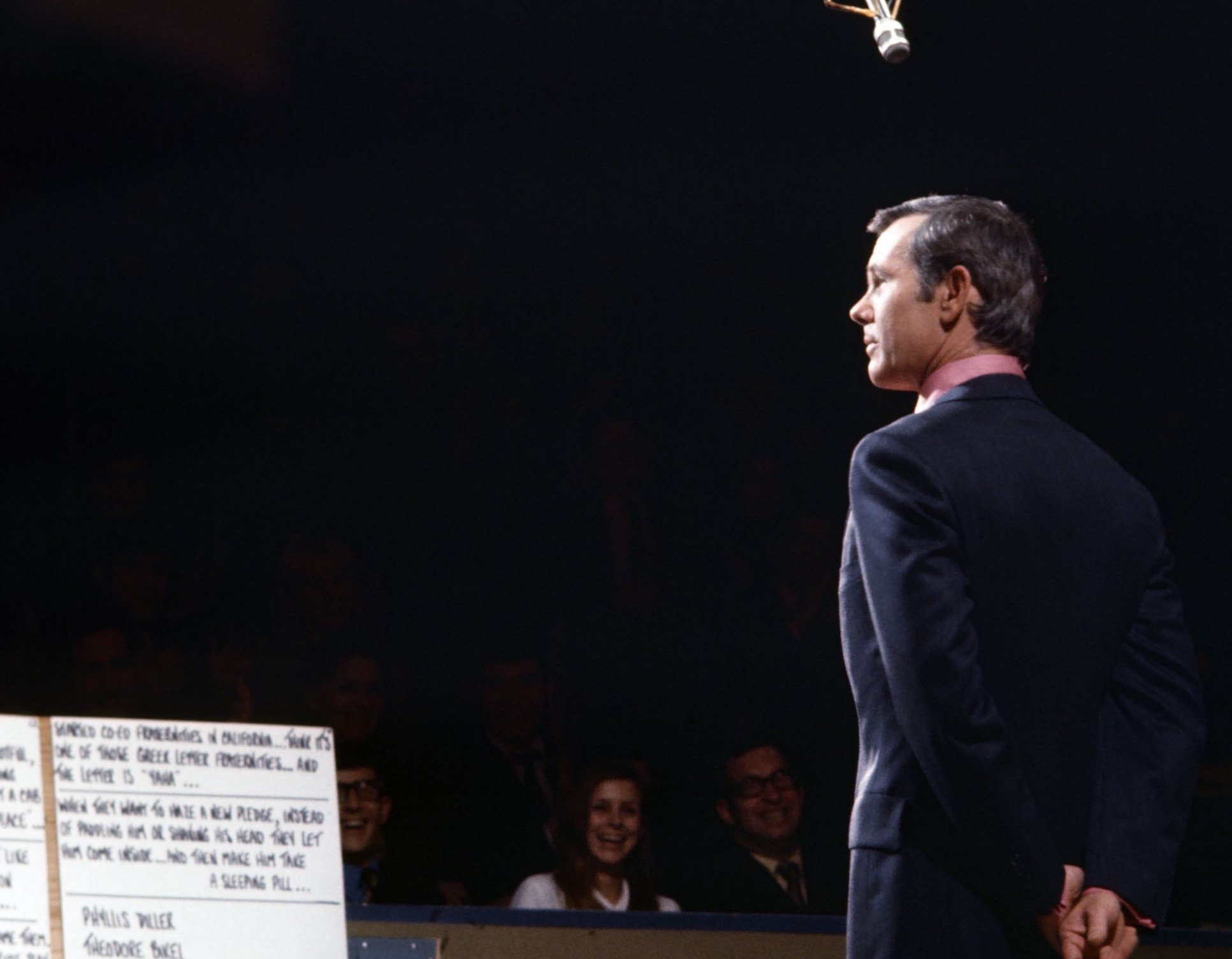 Johnny Carson hosts 'The Tonight Show' in 1970, dressed in a suit and standing with his hands behind his back