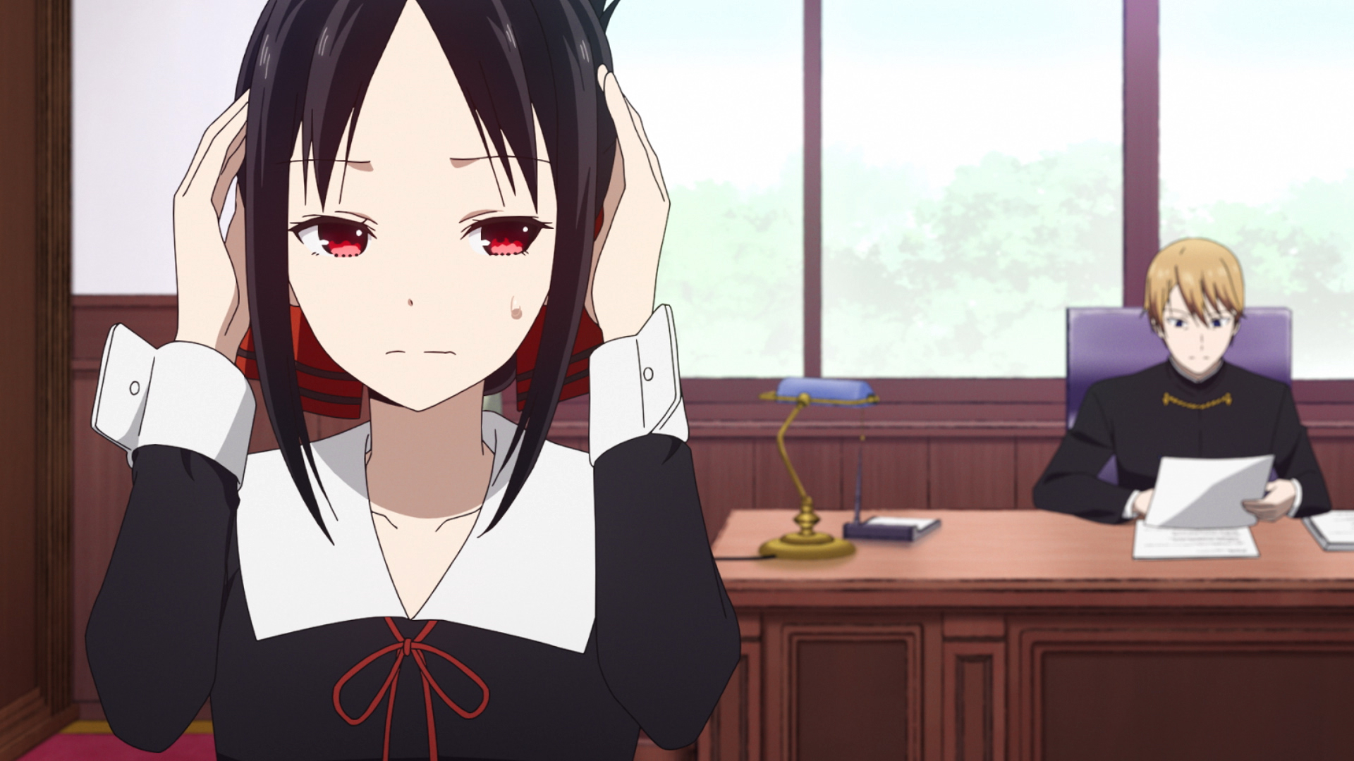 Screenshot of 'Kaguya-sama: Love Is War' Season 2 featuring Kaguya, who is covering her ears, and Miyuki, who is sitting at a desk behind her.