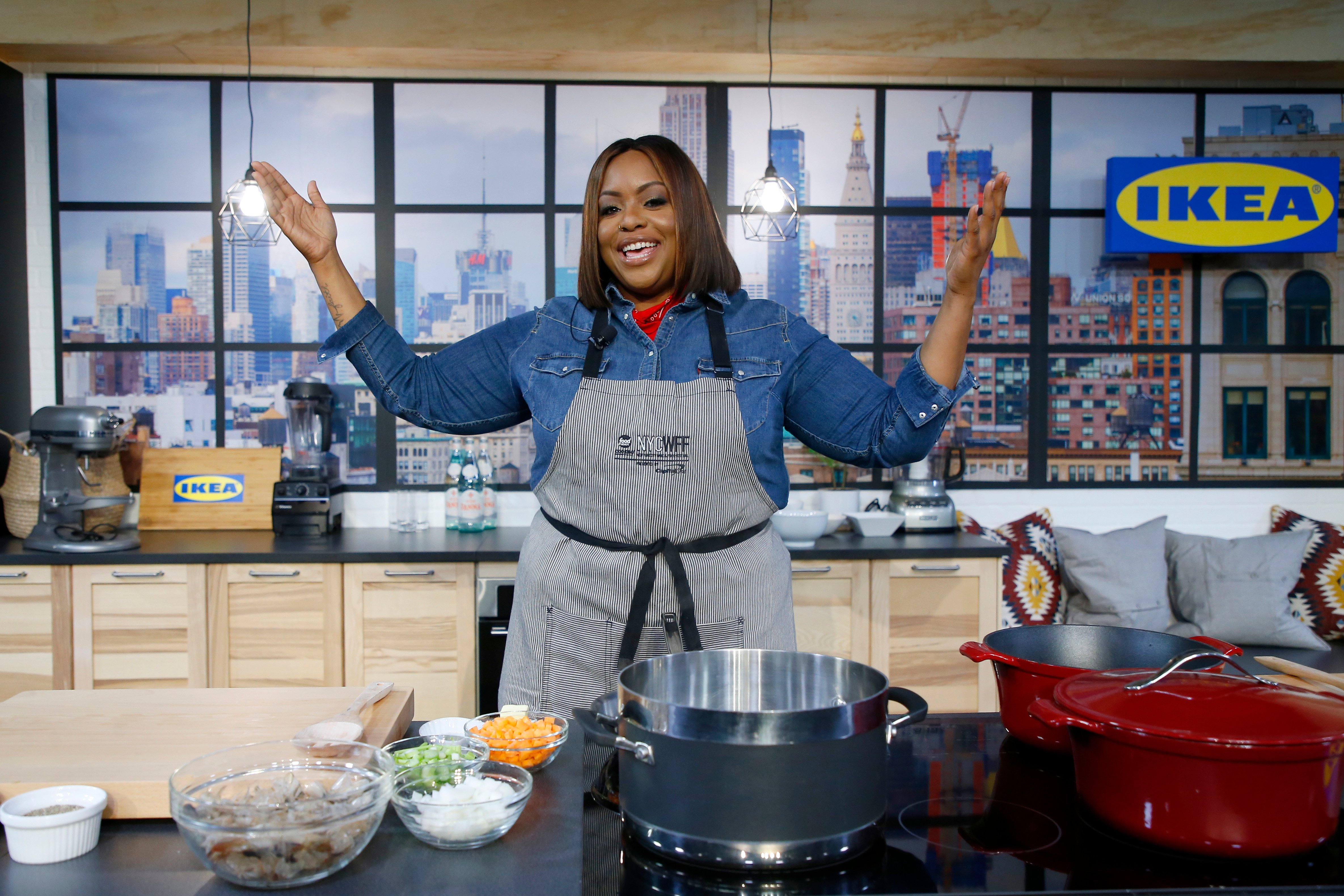 Food Network personality Kardea Brown is photographed in a long sleeved blue blouse.