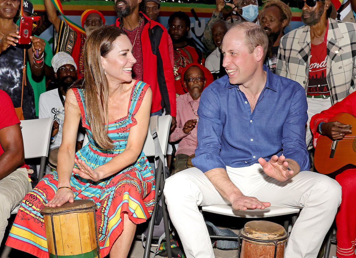 Kate Middleton and Prince William look at each other while they play drums in Jamaica