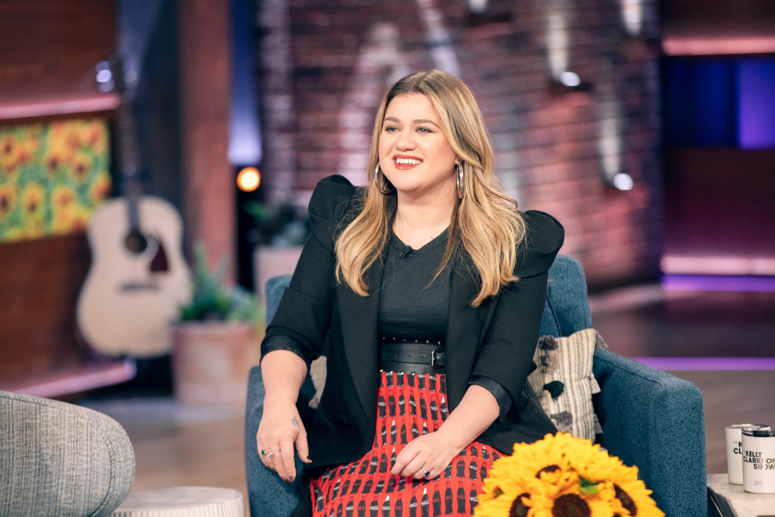 Kelly Clarkson seated on the set of her talk show