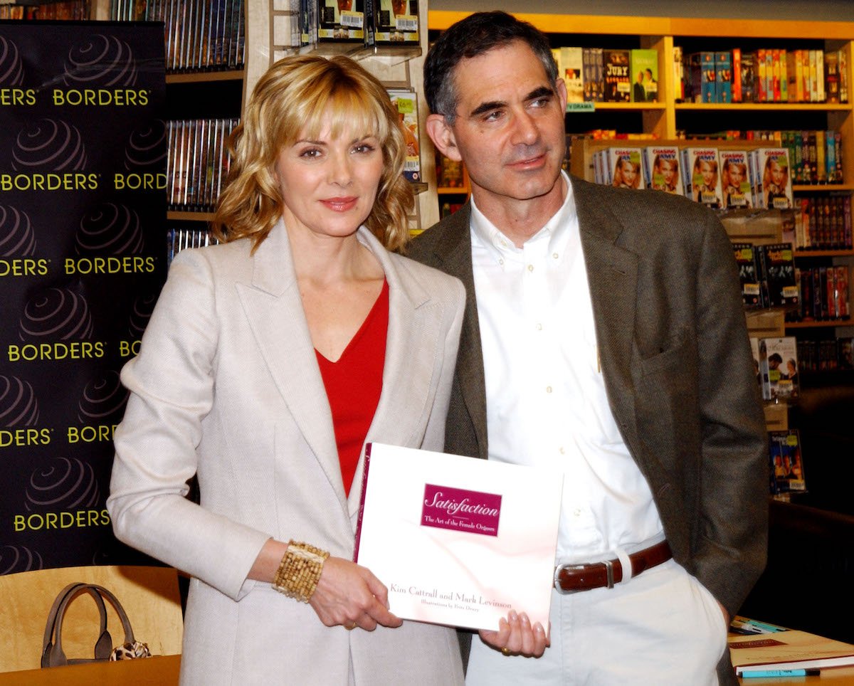 Actor Kim Cattrall and her husband Mark Levinson pose during an autograph signing session to promote their new book 'Satisfaction: The Art of the Female Orgasm' in 2002