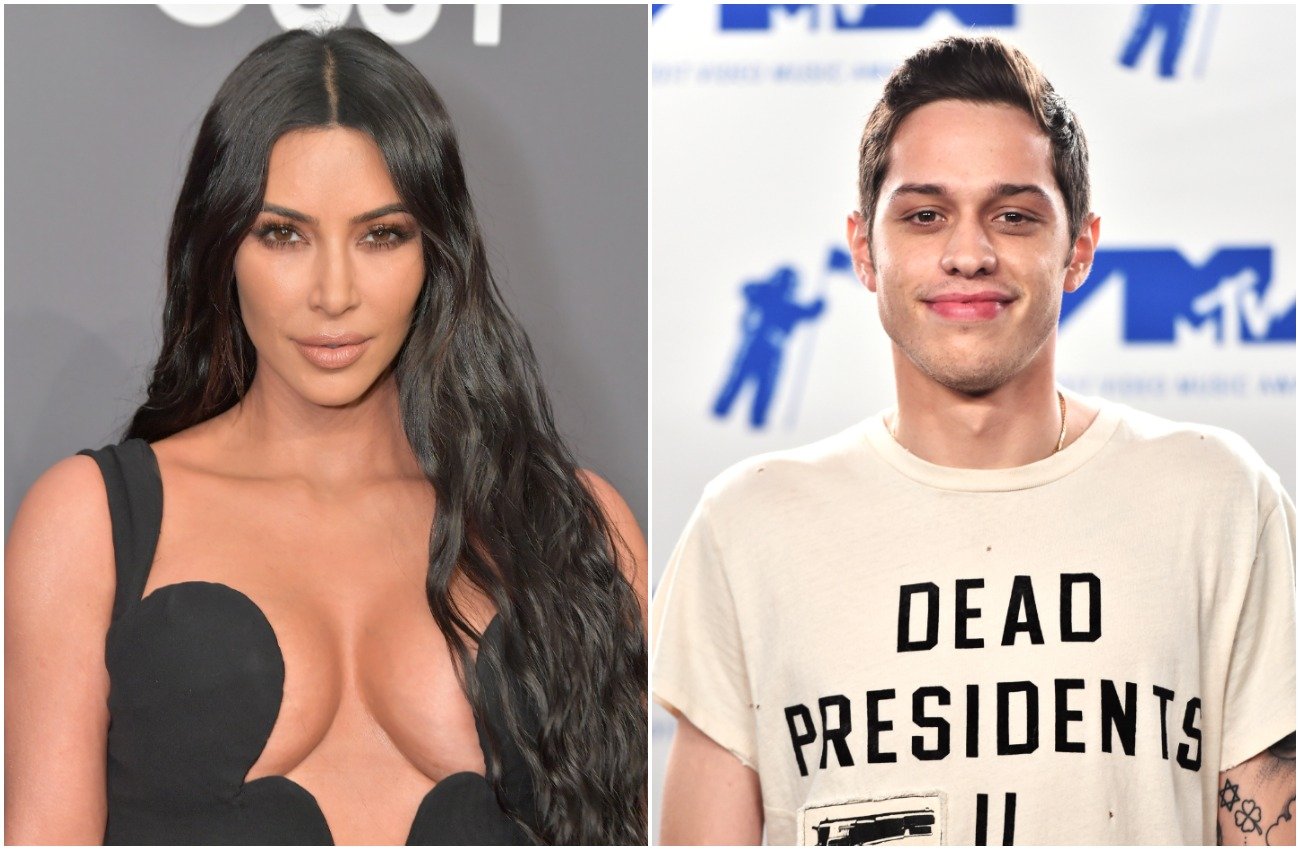 Kim Kardashian wearing a low-cut black outfit, Pete Davidson wearing a white T-shirt with black text