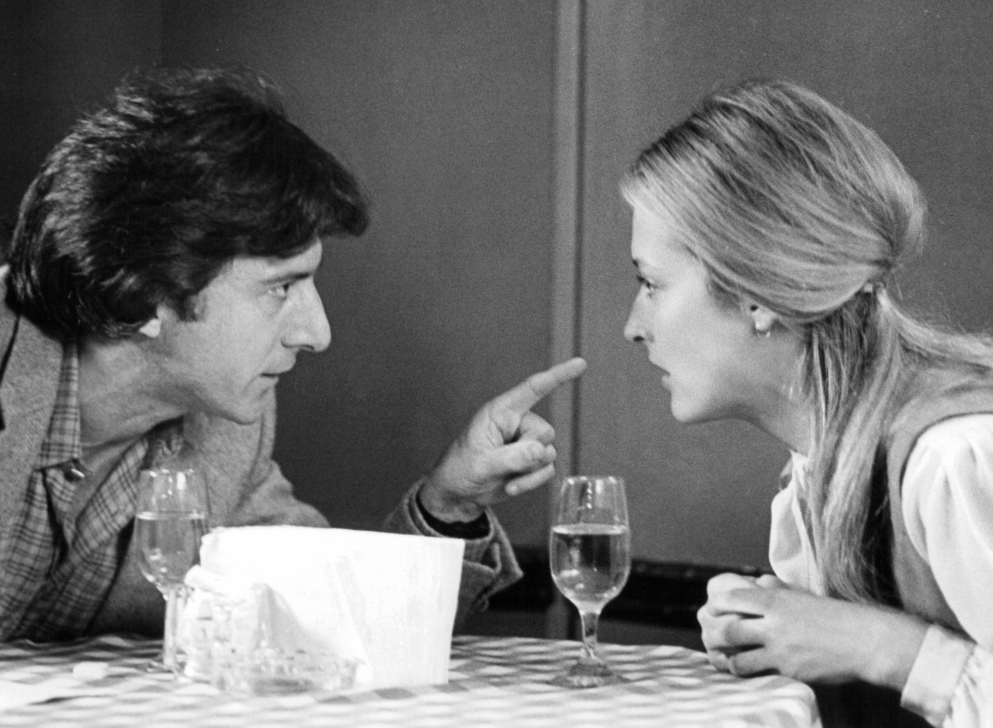 'Kramer vs. Kramer' Dustin Hoffman as Ted Kramer and Meryl Streep as Joanna pointing his finger in her face at a table with water glasses in between them