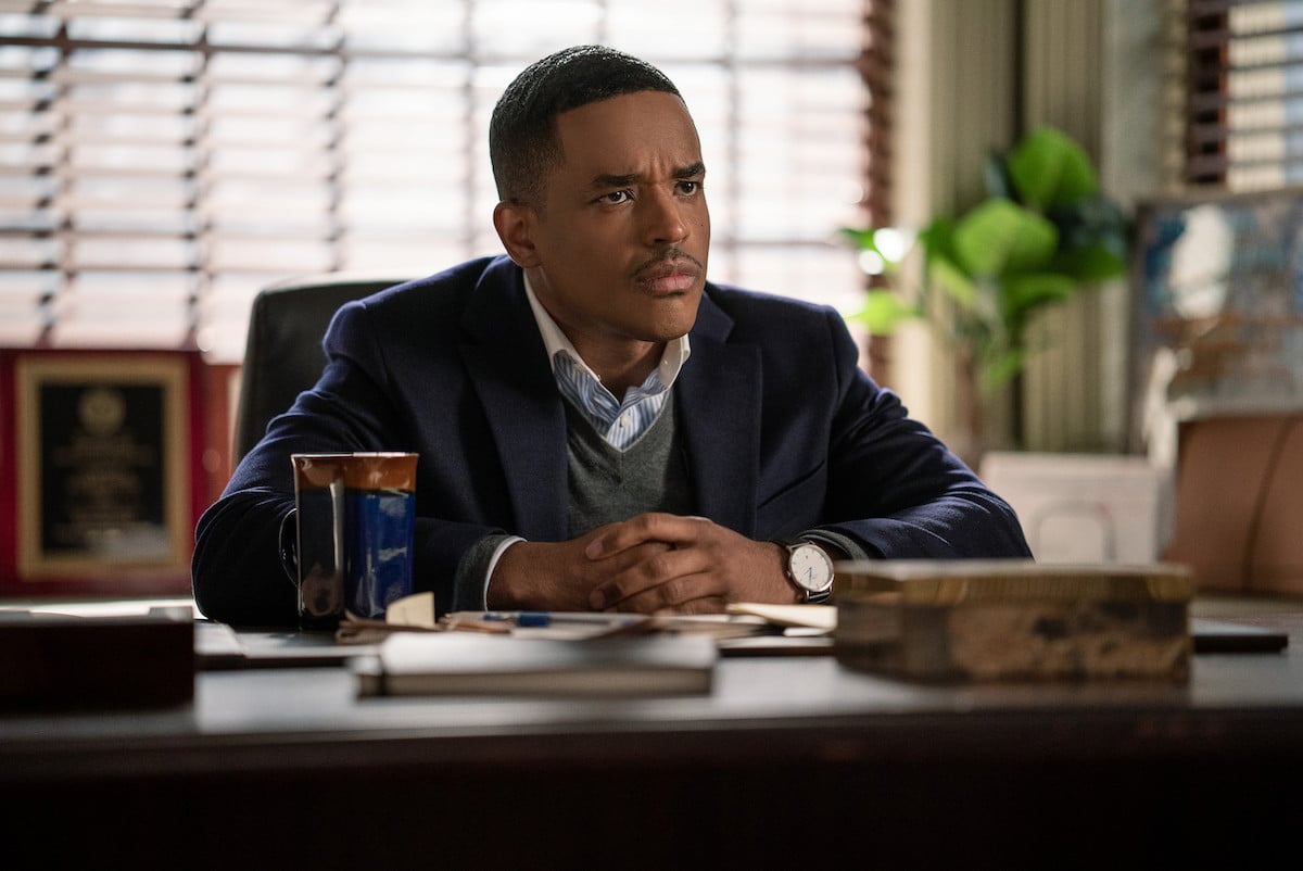 Larenz Tate as Rashad Tate sitting at a desk wearing a suit jacket in 'Power Book II: Ghost'