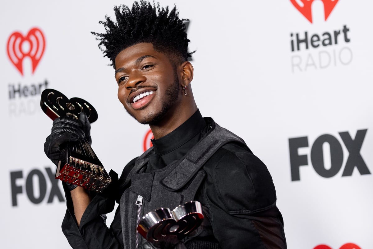 Lil Nas X poses with two iHeartRadio Music Awards on the red carpet in Los Angeles, CA.