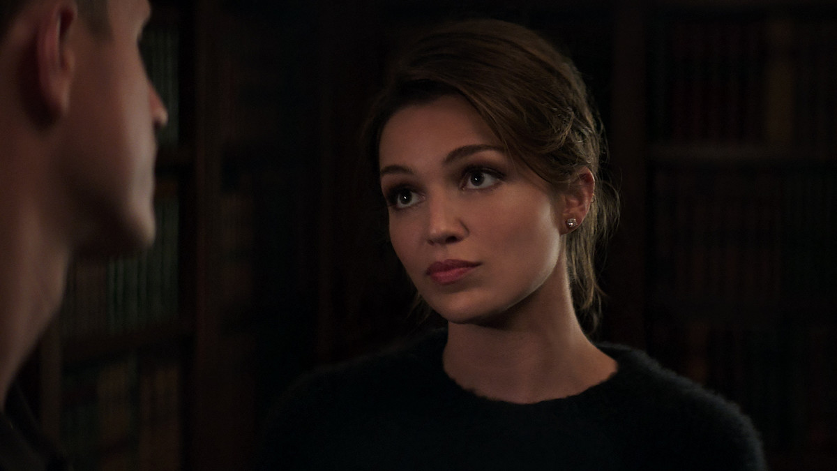 Lili Simmons as Claudia Flynn wearing an updo and a black shirtin 'Power Book IV: Force'