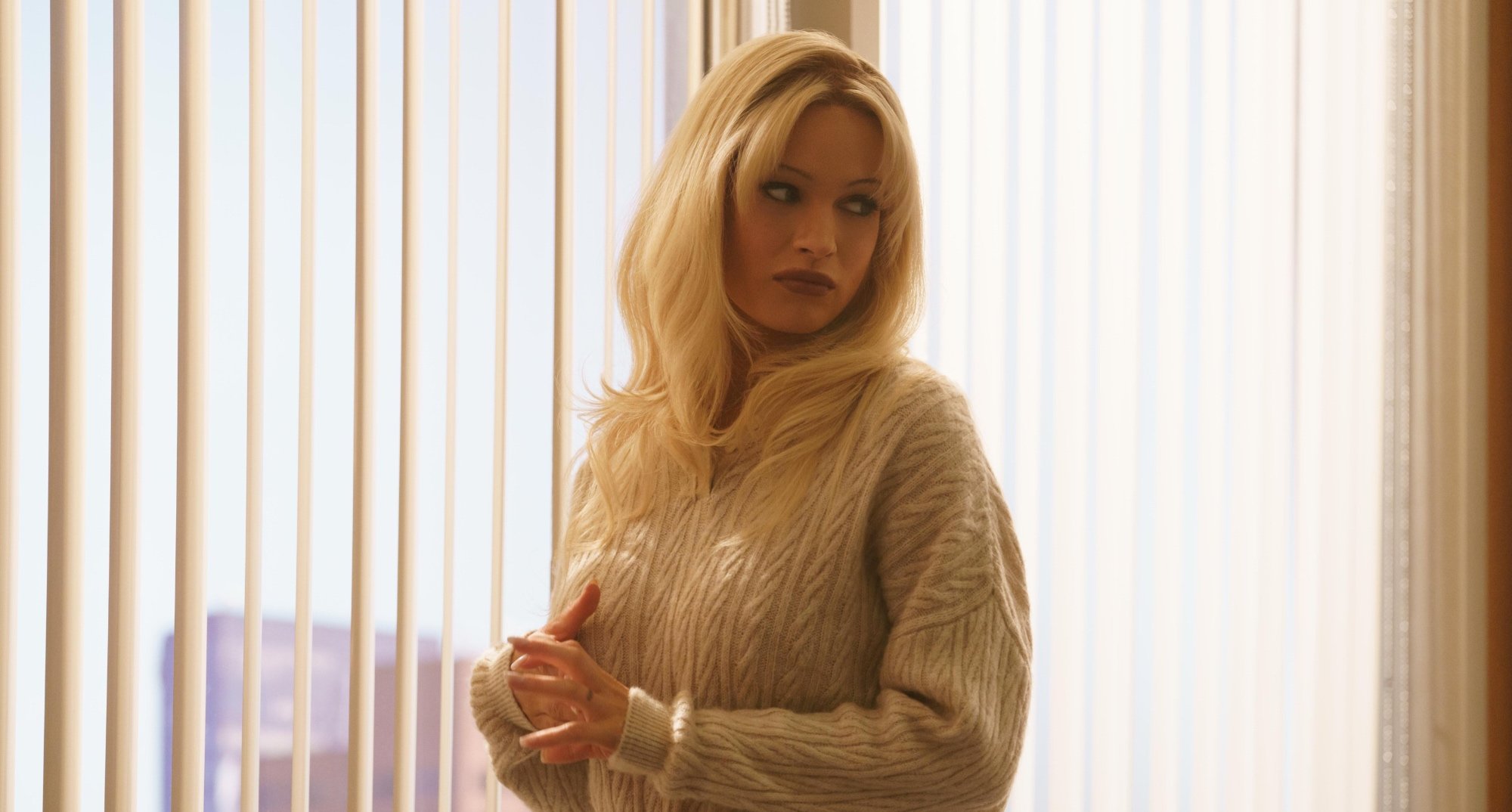 Lily James as Pamela Anderson in 'Pam & Tommy' wearing knit sweater.