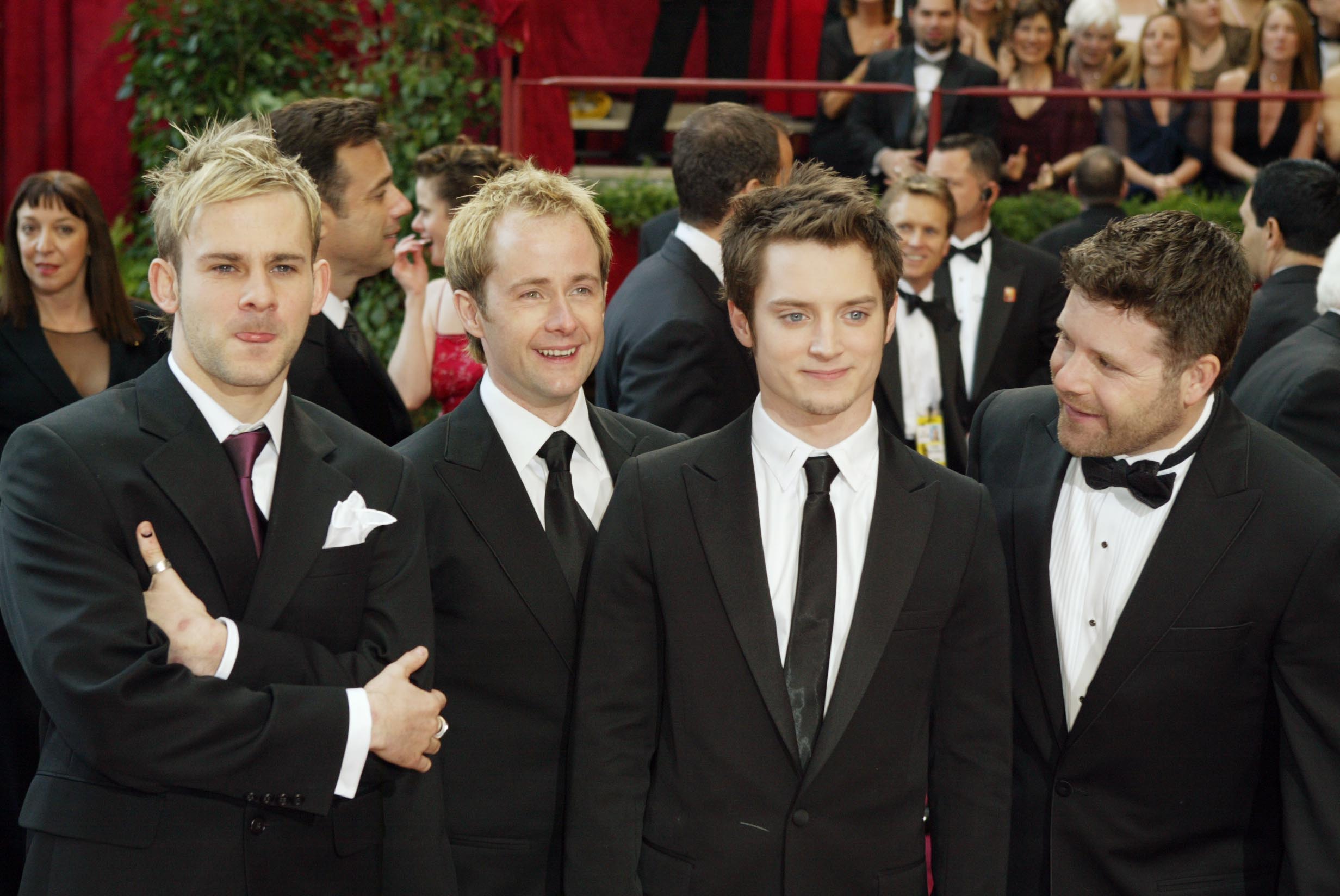 'The Lord of the Rings' stars Dominic Monaghan, Billy Boyd, Elijah Wood, and Sean Astin at the 2004 Oscars. They're standing next to one another and all wearing black suits.