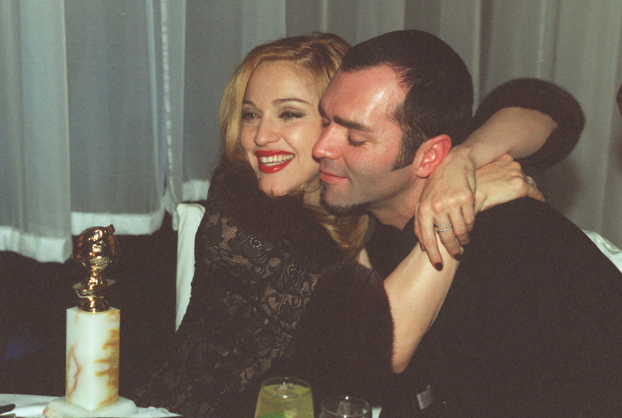 Madonna putting her arms around her brother, Christopher Ciccone
