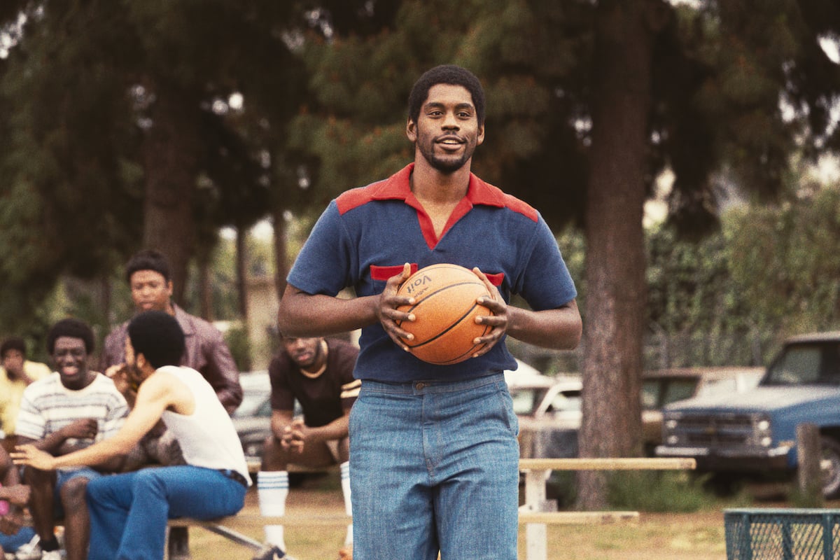 Magic Johnson actor Quincy Isaiah holds a basketball in 'Winning Time'