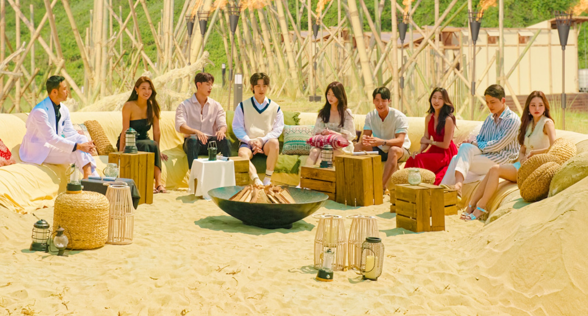 Main cast of 'Single's Inferno' sitting on beach in relation to season 2.