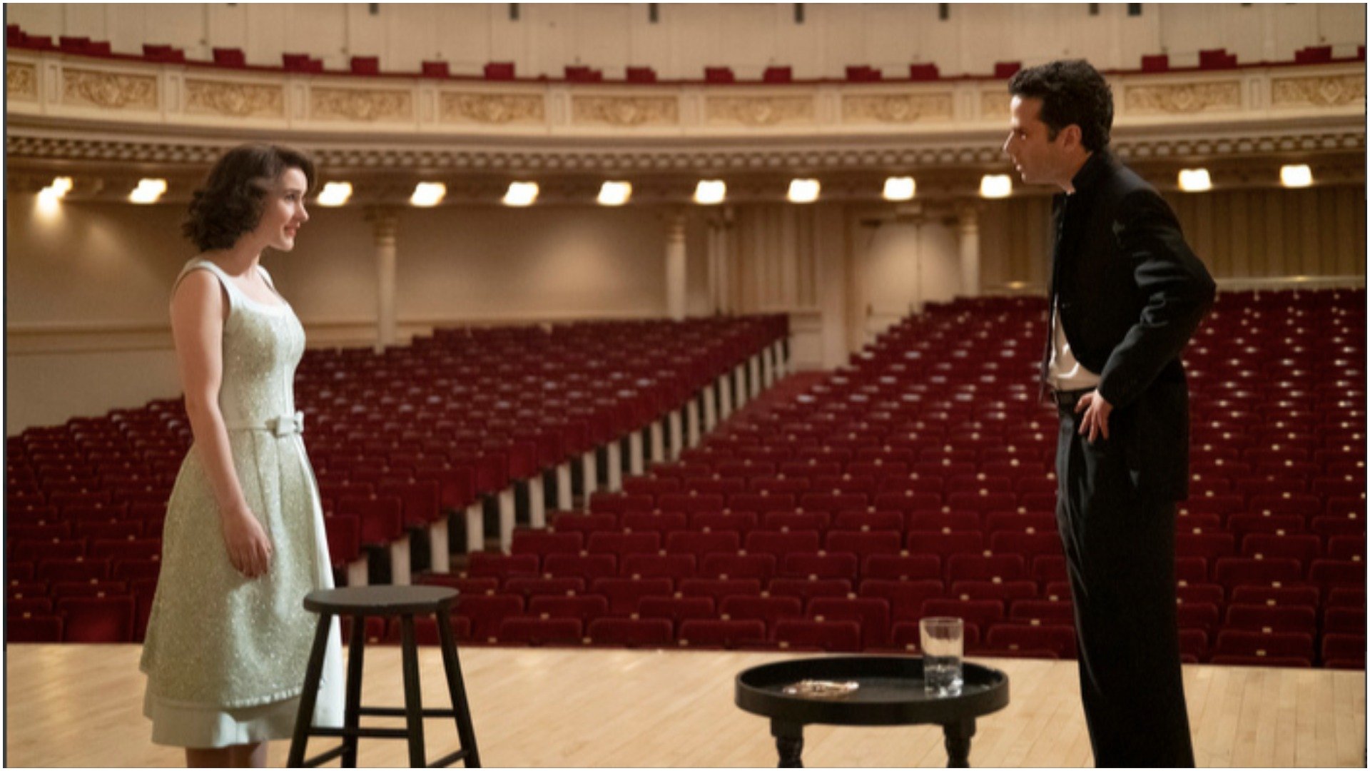 Rachel Brosnahan as Miriam 'Midge' Maisel' and Luke Kirby as 'Lenny Bruce' fight on an empty Carnegie Hall stage  