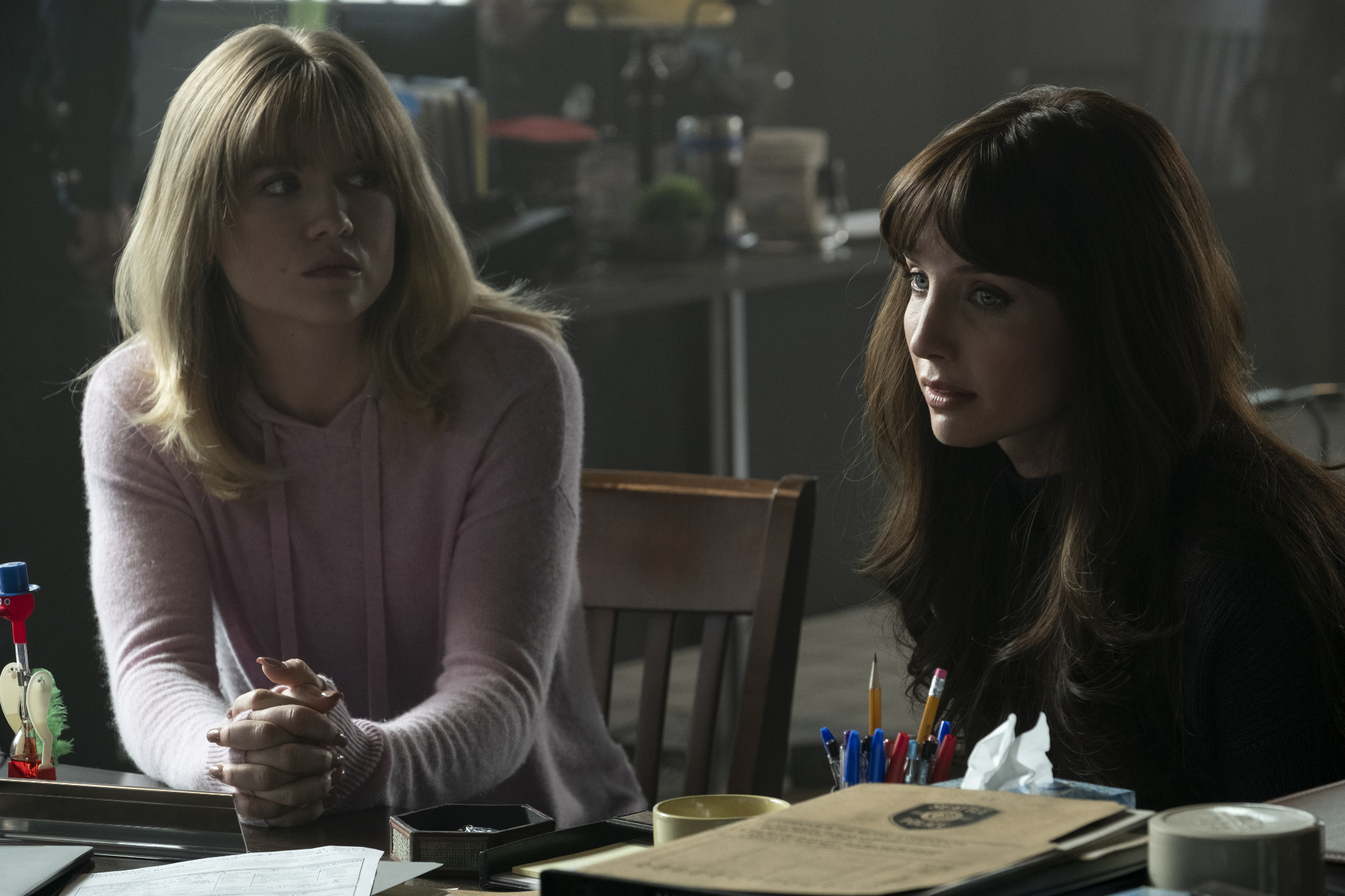 'Malignant' Maddie Hasson as Sydney and Annabelle Wallis as Madison, the twin of Gabriel sitting in chairs at the police station looking concerned