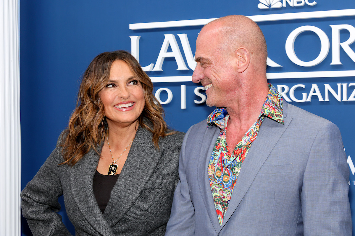 Mariska Hargitay and Christopher Meloni smile at each other while standing on the red carpet for 'Law & Order' in 2022