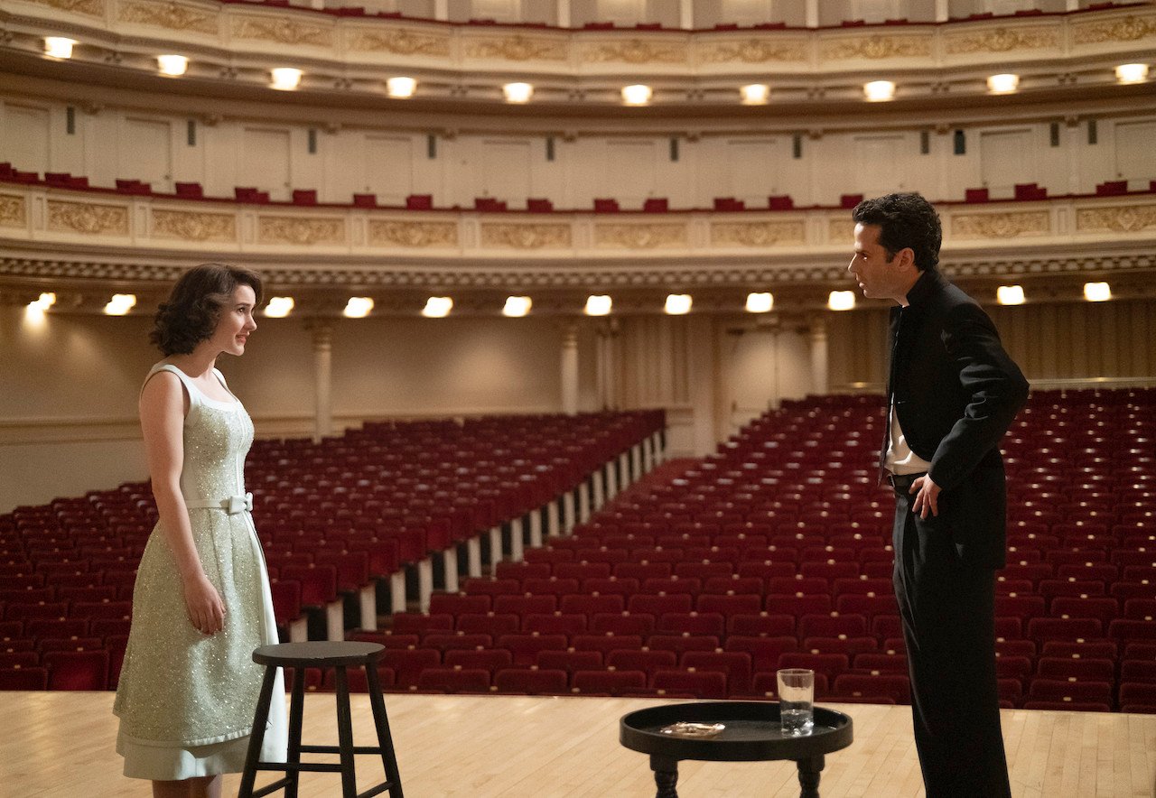 Rachel Brosnahan as Midge Maisel and Luke Kirby as Lenny Bruce talk to each other on the stage of Carnegie Hall in 'The Marvelous Mrs. Maisel'.