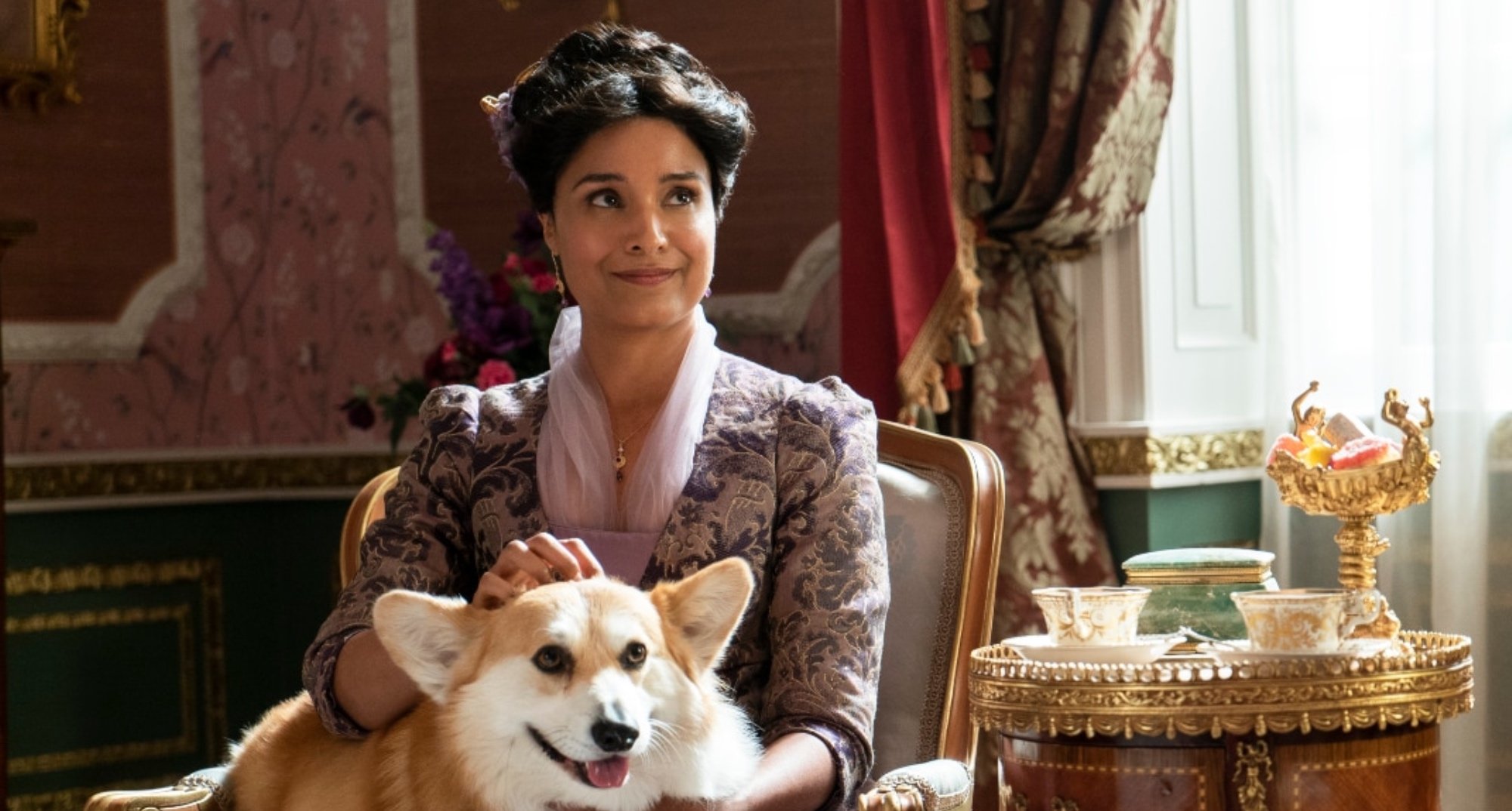 Mary Sharma in 'Bridgerton' Season 2 petting her dog Newton.