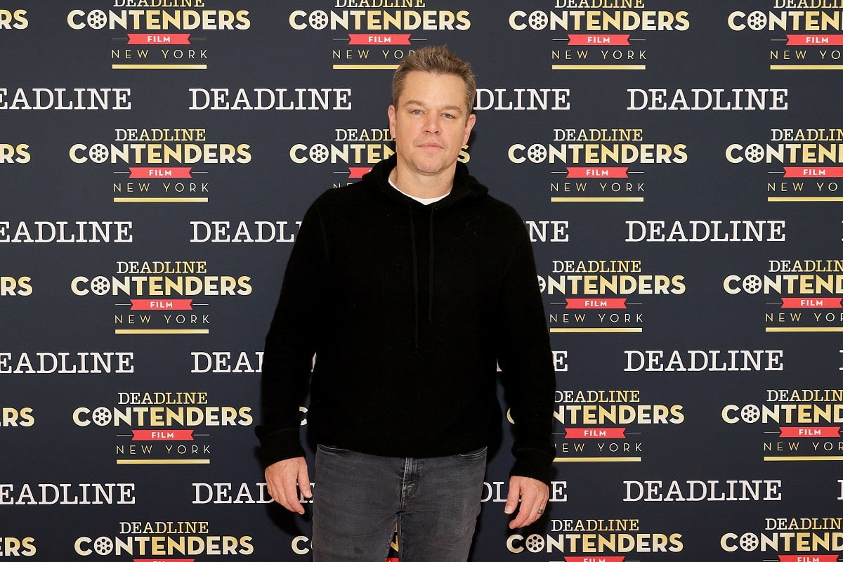 Matt Damon posing while wearing a black sweater.