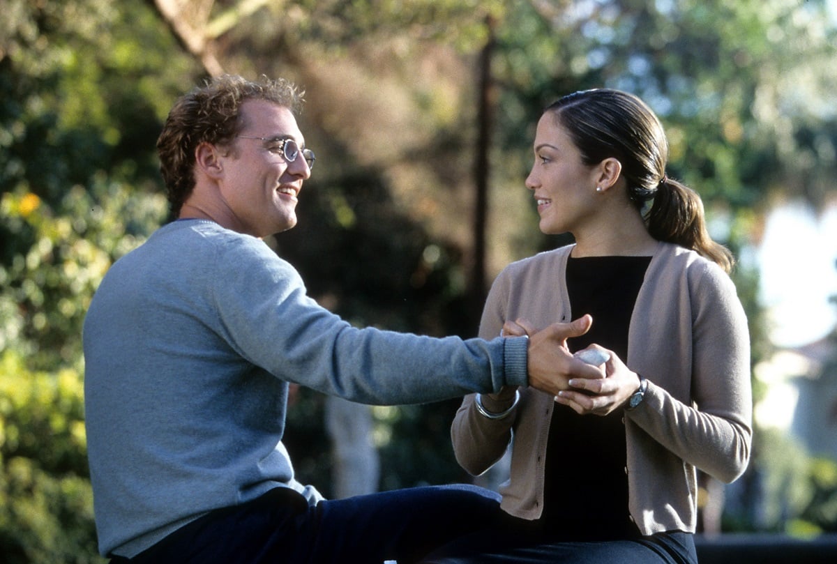 Matthew McConaughey and Jennifer Lopez smiling at each other.