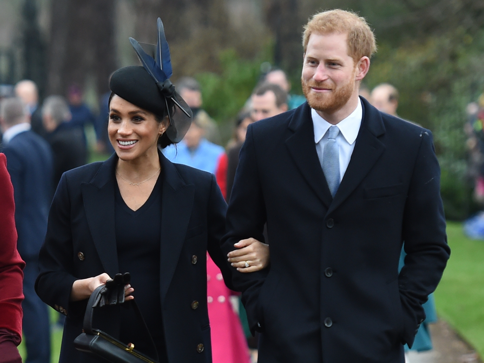 Meghan Markle and Prince Harry walking arm-in-arm to the Christmas Day service at St Mary Magdalene Church in 2018
