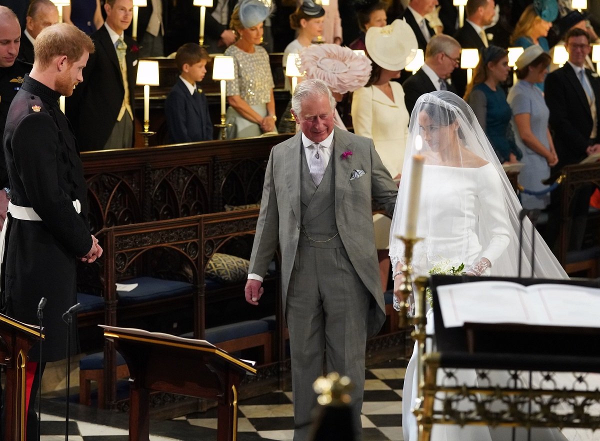 Meghan Markle arrives at the altar to marry Prince Harry accompanied by his father, Prince Charles