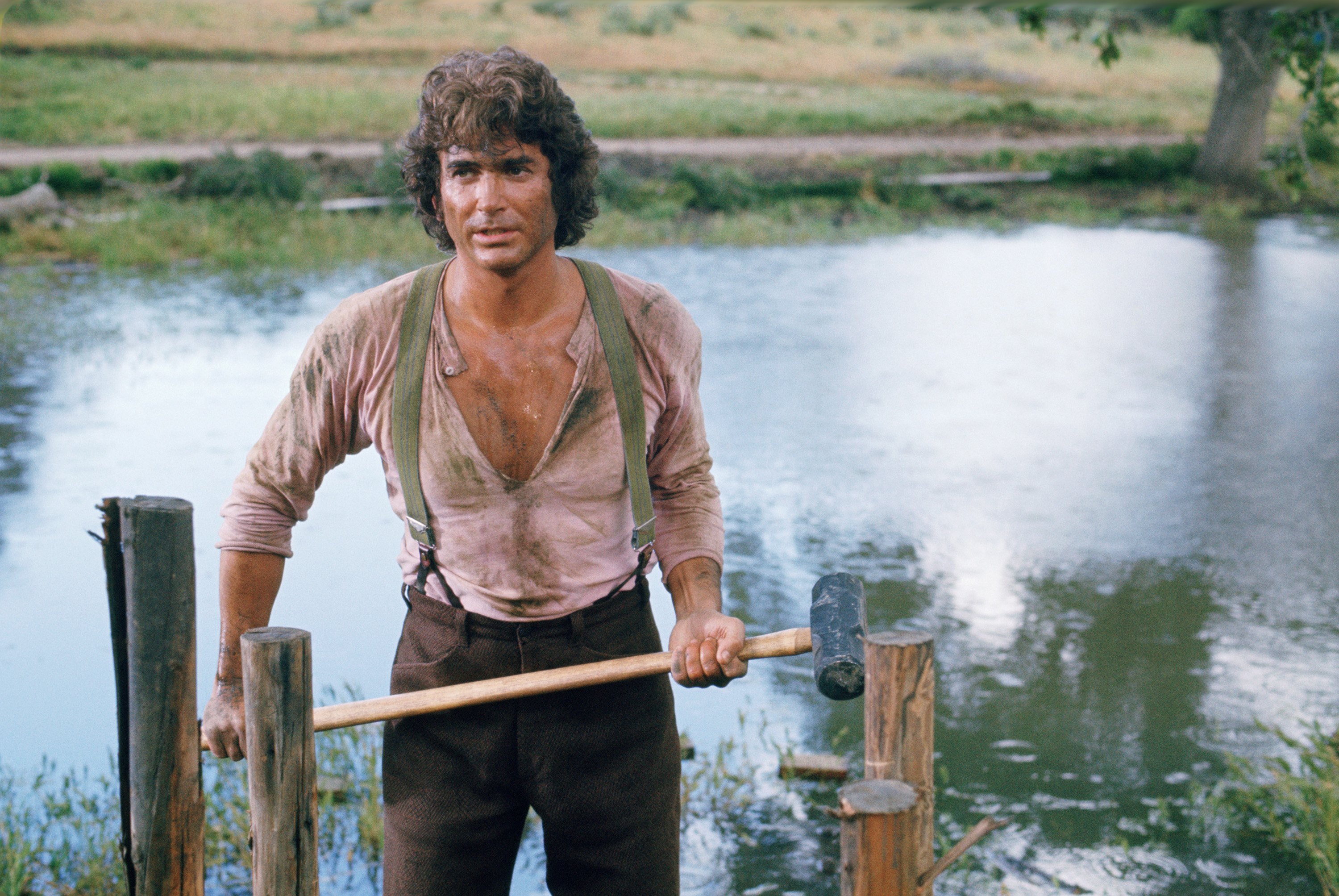 Michael Landon holds an ax while on the Little House on the Prairie set.