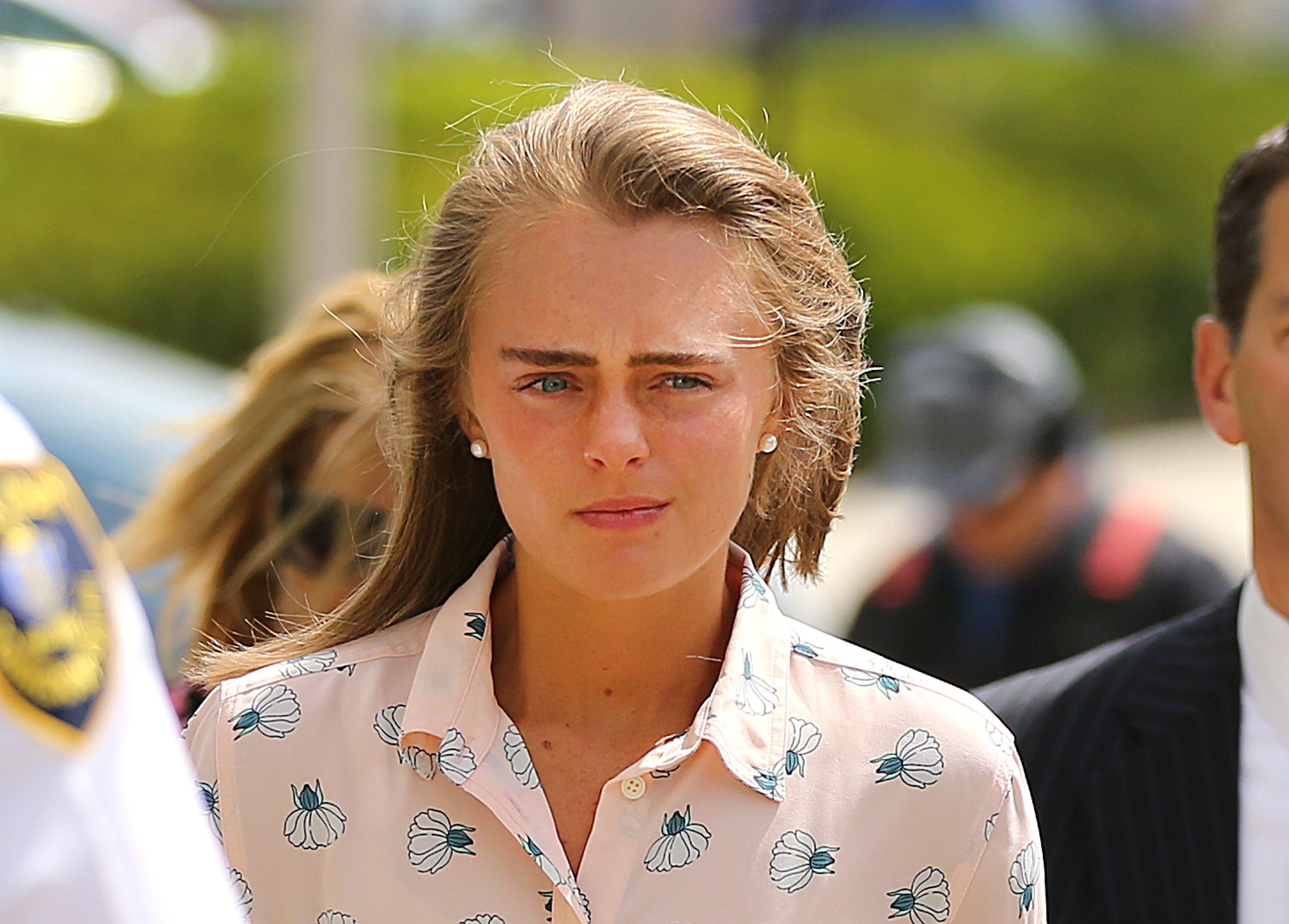 Michelle Carter, wearing a pink button-down shirt, arrives at court in 2017