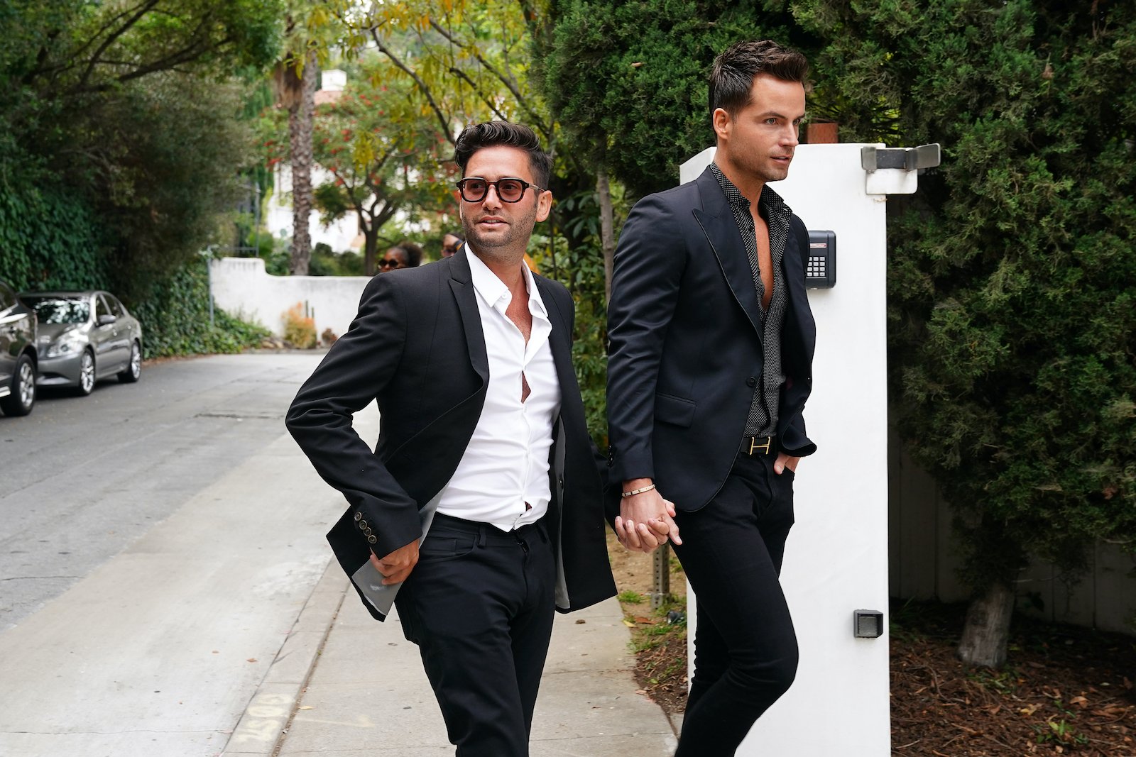 Josh Flagg and Bobby Boyd hold hands on their way into a listing on 'Million Dollar Listing'