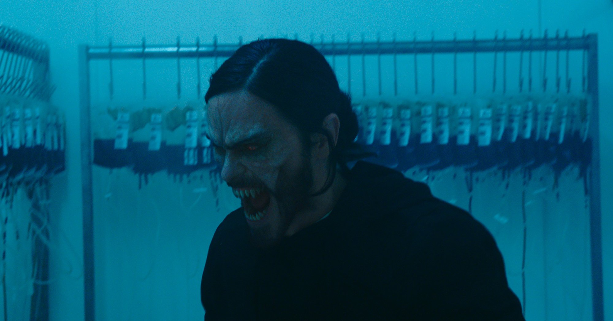 'Morbius' Jared Leto as Dr. Michael Morbius with vampire teeth in front of a rack full of blood bags