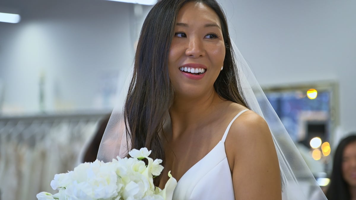 Natalie Lee wearing a wedding dress, smiling on 'Love Is Blind' Season 2.
