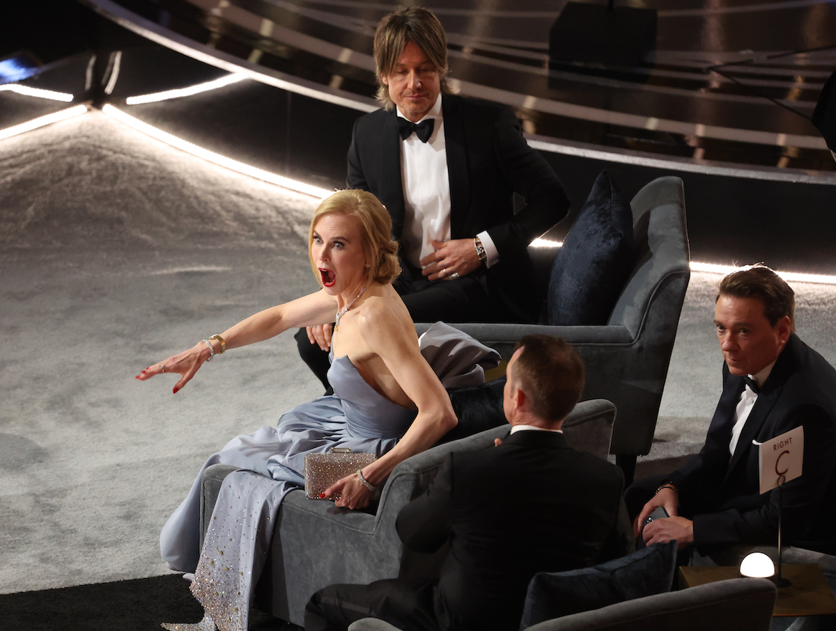 Actor Nicole Kidman looks shocked during the 2022 Oscars as her husband Keith Urban gets seated beside her