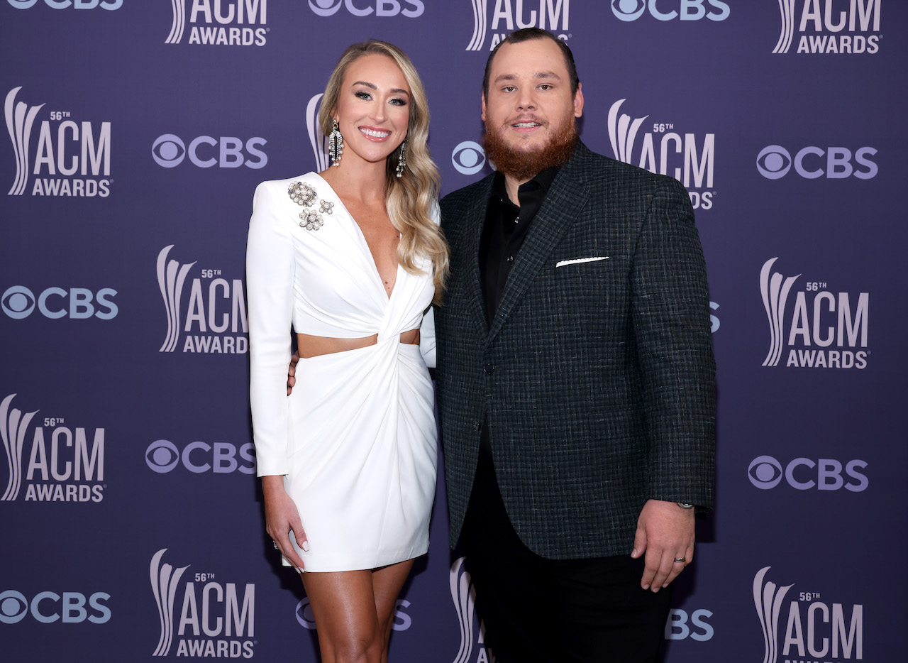 Nicole Hocking in a white dress standing next to husband, Luke Combs, in a black suit