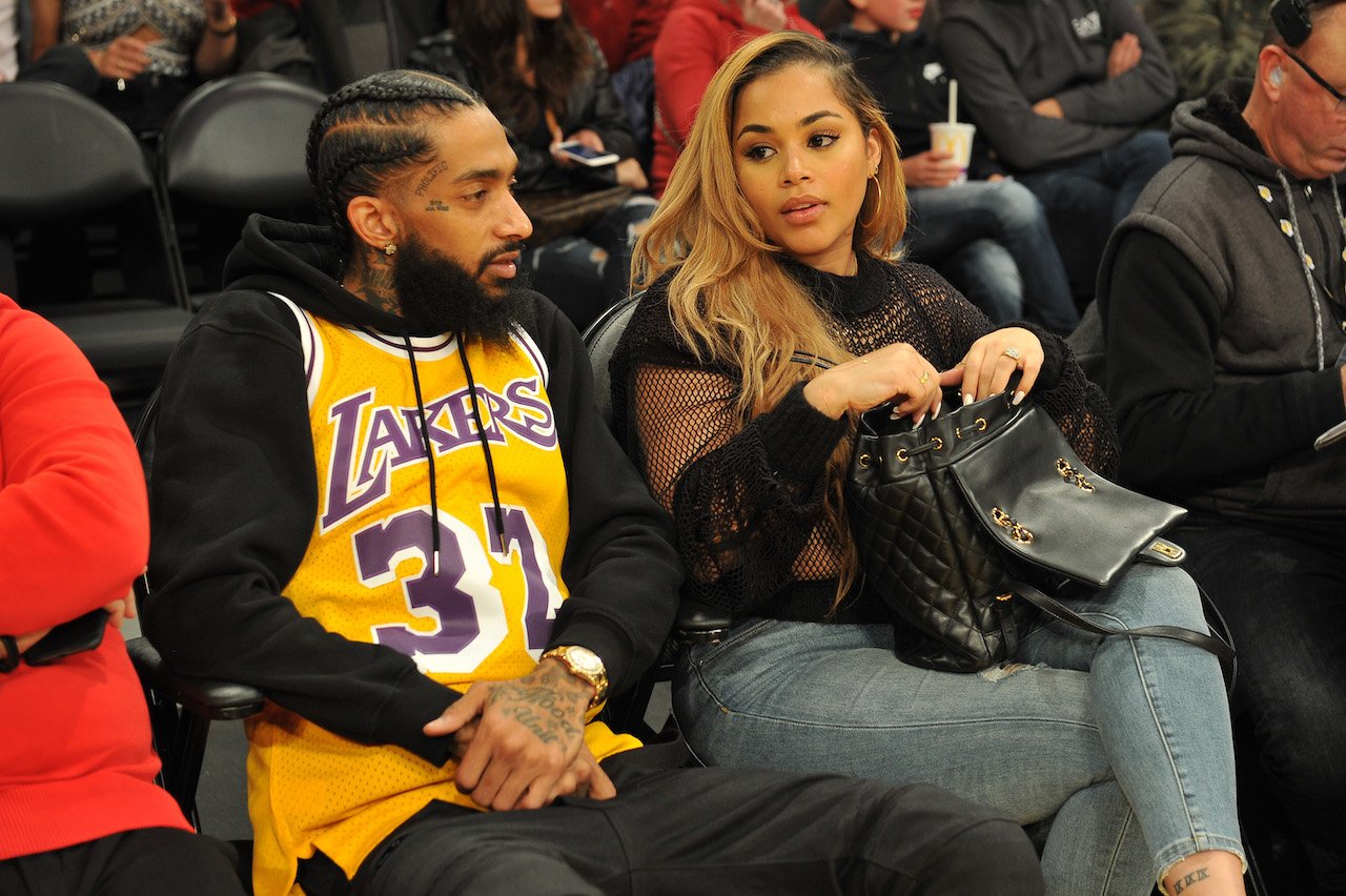 Lauren London and Nipsey Hussle sit courtside at basketball game