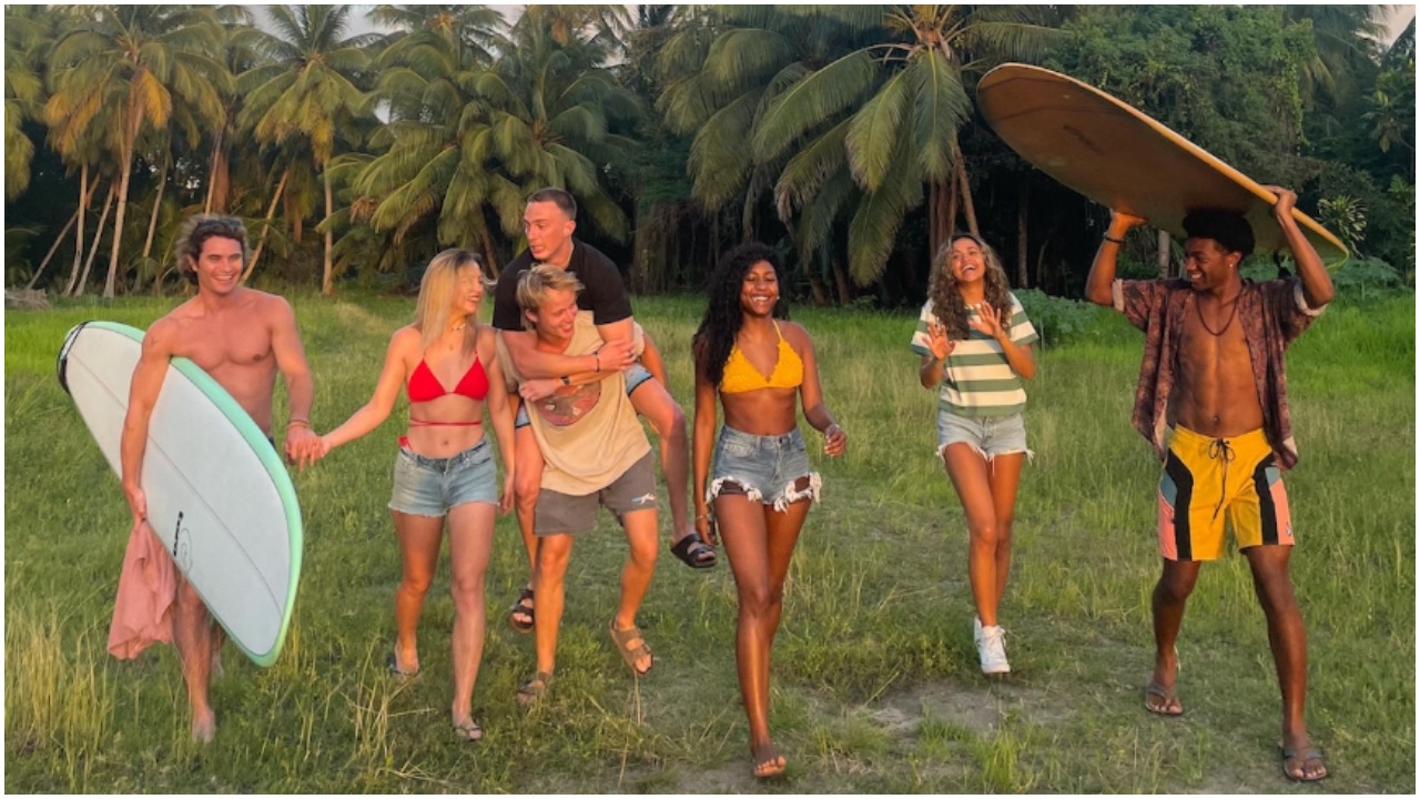 Chase Stokes, Madelyn Cline, Rudy Pankow holding Drew Starkey, Carlacia Grant, Madison Bailey, and Jonathan Daviss in a photo from the filming location of 'Outer Banks' Season 3