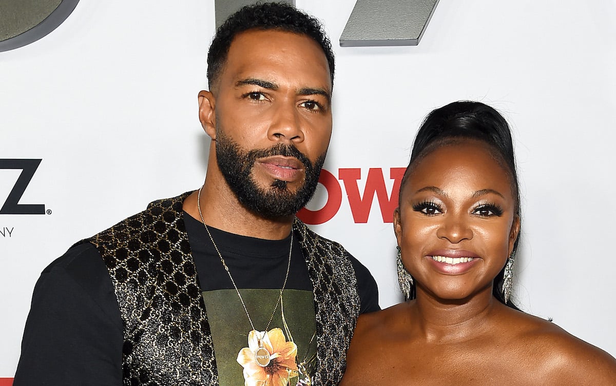 Omari Hardwick and Naturi Naughton pose for a photo in black outfits at a TV event