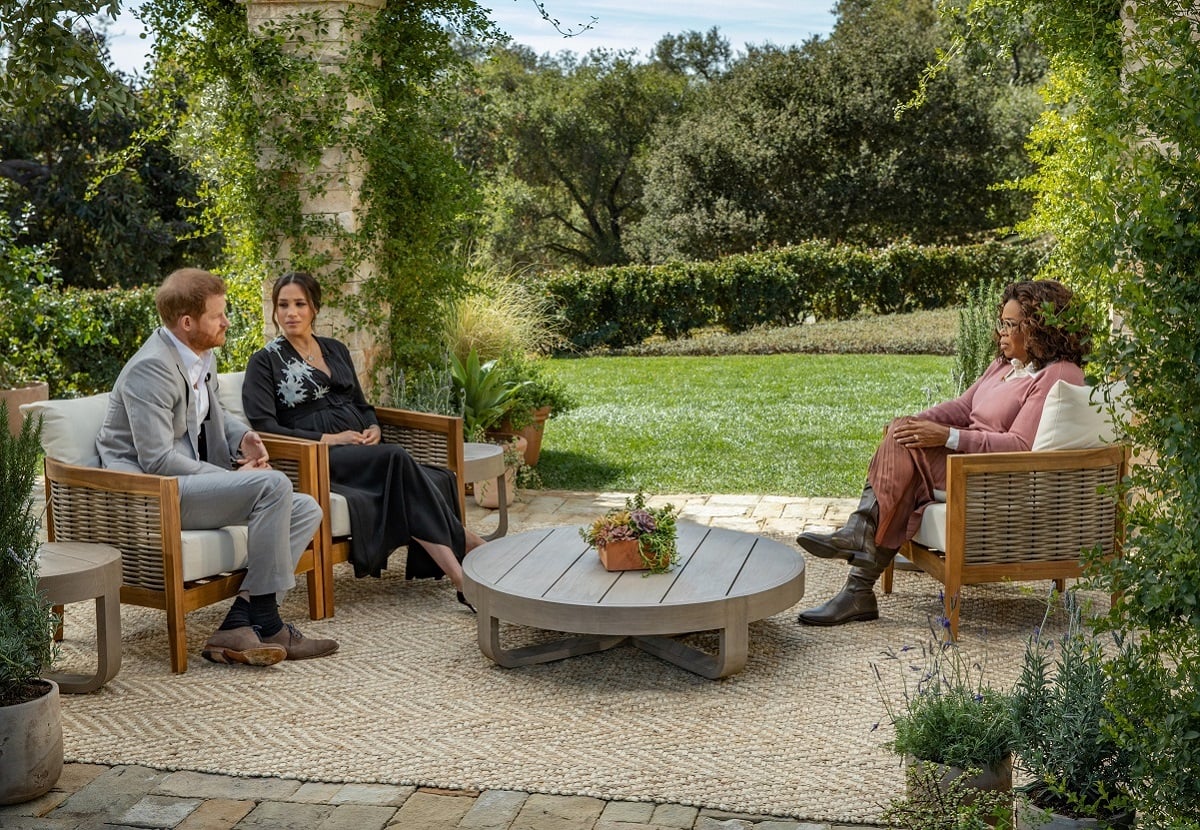 Oprah Winfrey sitting across from Prince Harry and Meghan Markle as she interviews them for CBS special